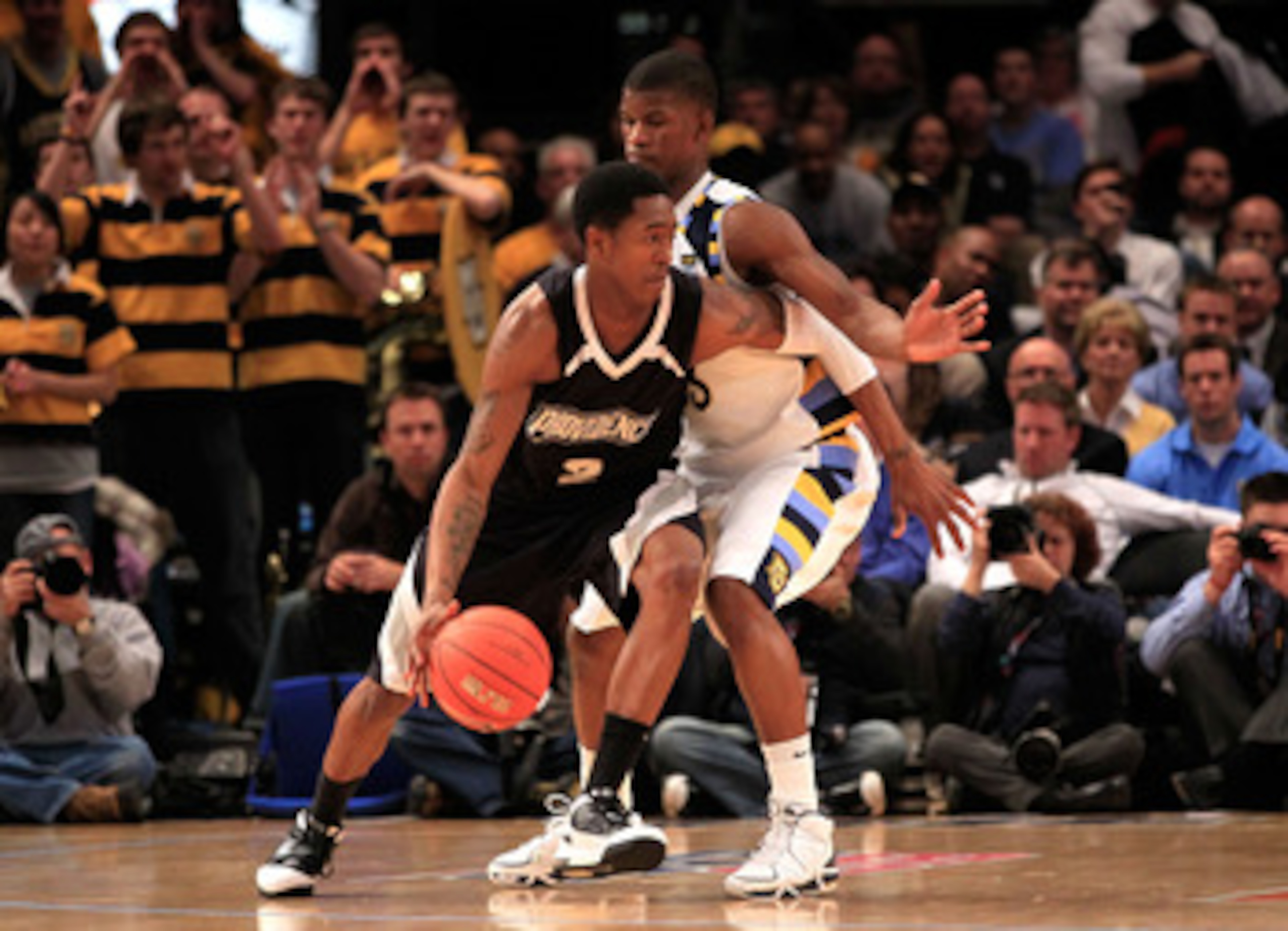 NEW YORK, NY - MARCH 08: Marshon Brooks #2 of the Providence Friars dribbles the ball against Jimmy Butler #33 of the Marquette Golden Eagles during the first round of the 2011 Big East Men's Basketball Tournament presented by American Eagle Outfitters at