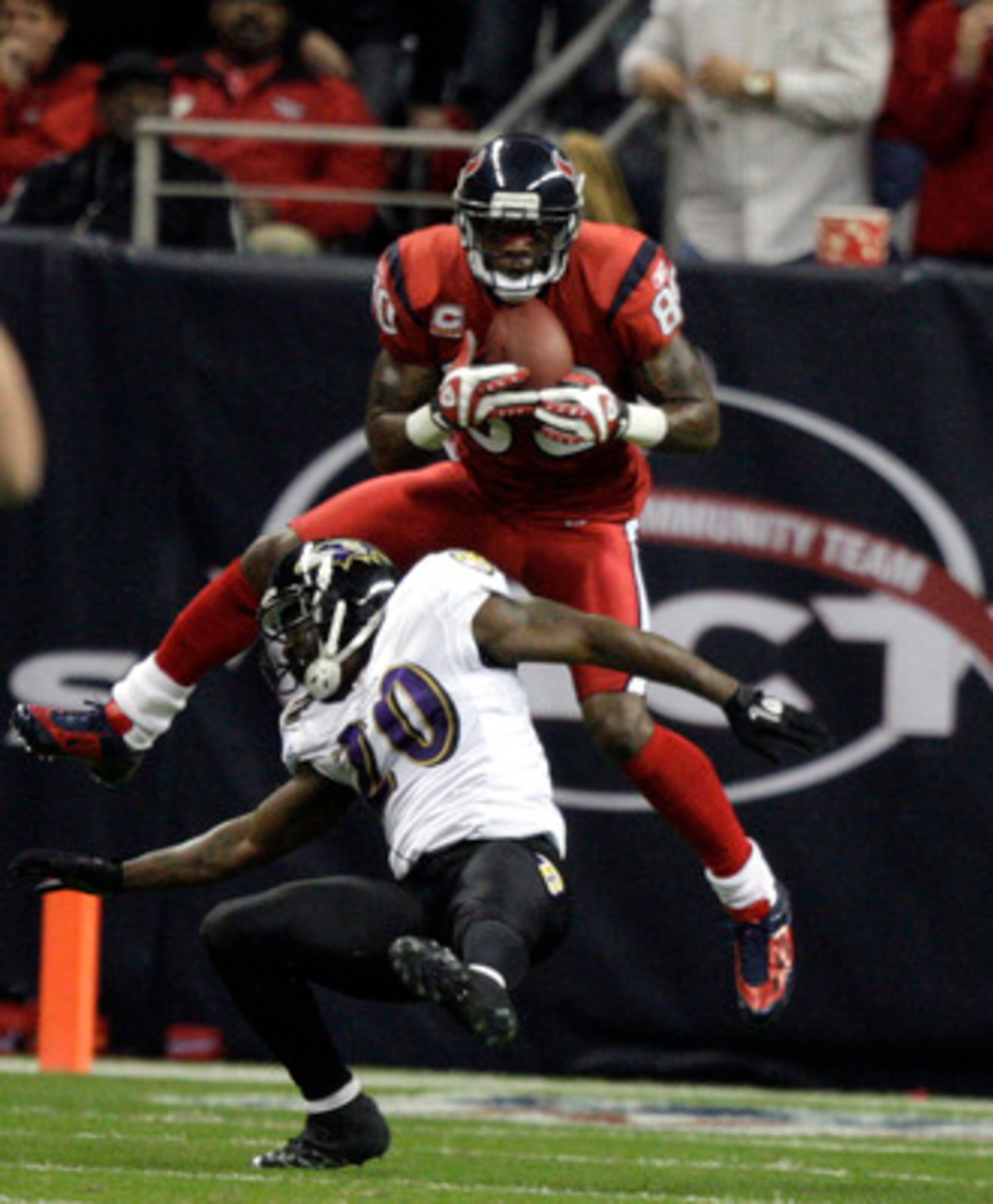 HOUSTON, TX - DECEMBER 13: Wide receiver Andre Johnson #80 of the Houston Texans scores on a pass as he goes over safety Ed Reed #20 of the Baltimore Ravens in the second quarter at Reliant Stadium on December 13, 2010 in Houston, Texas. (Photo by Bob L HOUSTON, TX - DECEMBER 13: Wide receiver Andre Johnson #80 of the Houston Texans scores on a pass as he goes over safety Ed Reed #20 of the Baltimore Ravens in the second quarter at Reliant Stadium on December 13, 2010 in Houston, Texas. (Photo by Bob L