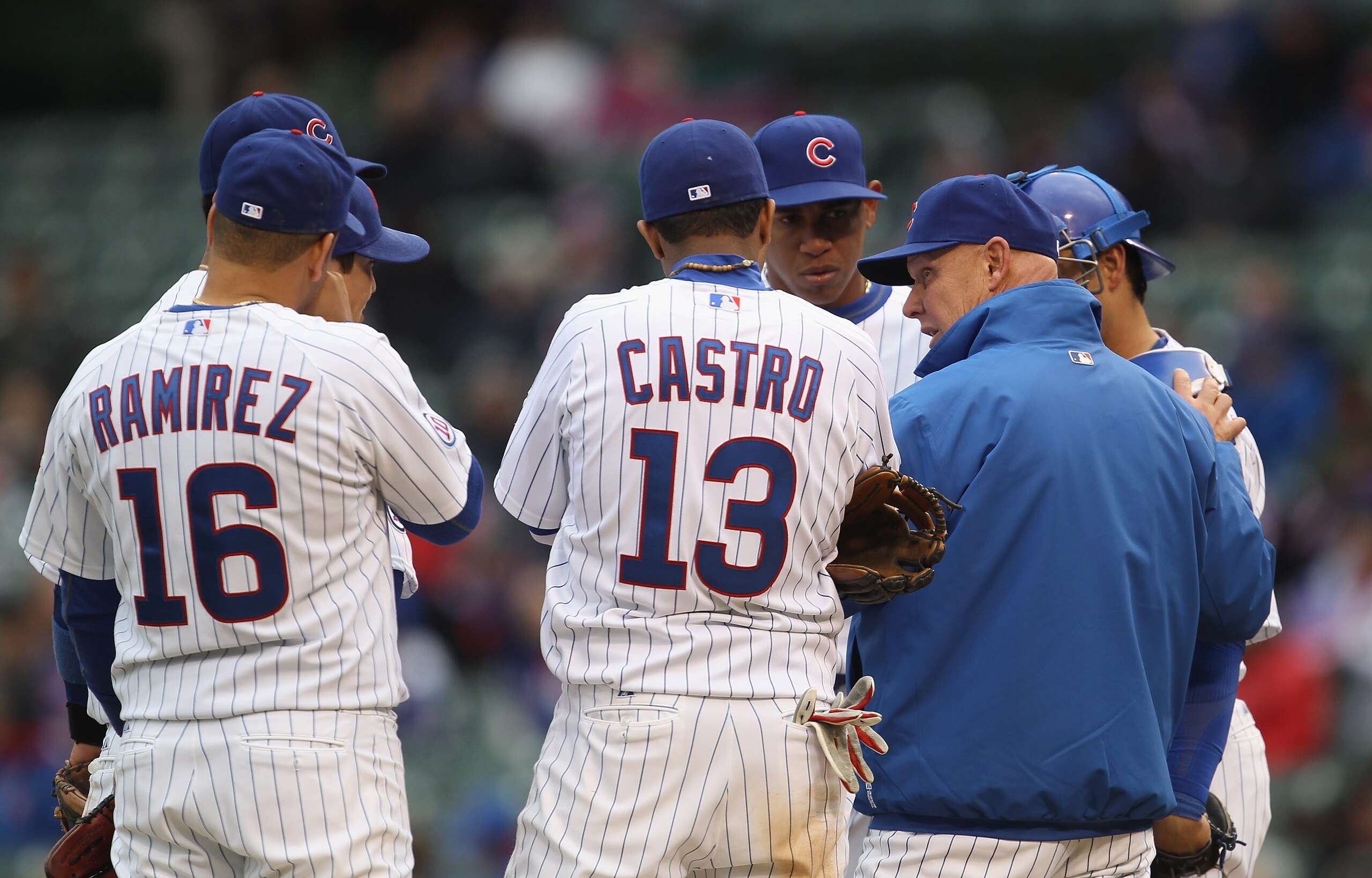 CHICAGO, IL - APRIL 20: Manager Mike Quade #8 of the Chicago Cubs talks to (L-R) Aramis Ramirez #16, Starlin Castro #13, Carlos Marmol #49 and Geovany Soto #18 against the San Diego Padres at Wrigley Field on April 20, 2011 in Chicago, Illinois. The Cubs