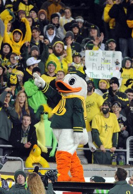 EUGENE, OR - NOVEMBER 26: Oregon Ducks fans cheer as mascot 'Puddles' prepares to do some push ups in the fourth quarter of the game against the Arizona Wildcats at Autzen Stadium on November 26, 2010 in Eugene, Oregon. Puddles does push ups for every poi EUGENE, OR - NOVEMBER 26: Oregon Ducks fans cheer as mascot 'Puddles' prepares to do some push ups in the fourth quarter of the game against the Arizona Wildcats at Autzen Stadium on November 26, 2010 in Eugene, Oregon. Puddles does push ups for every poi