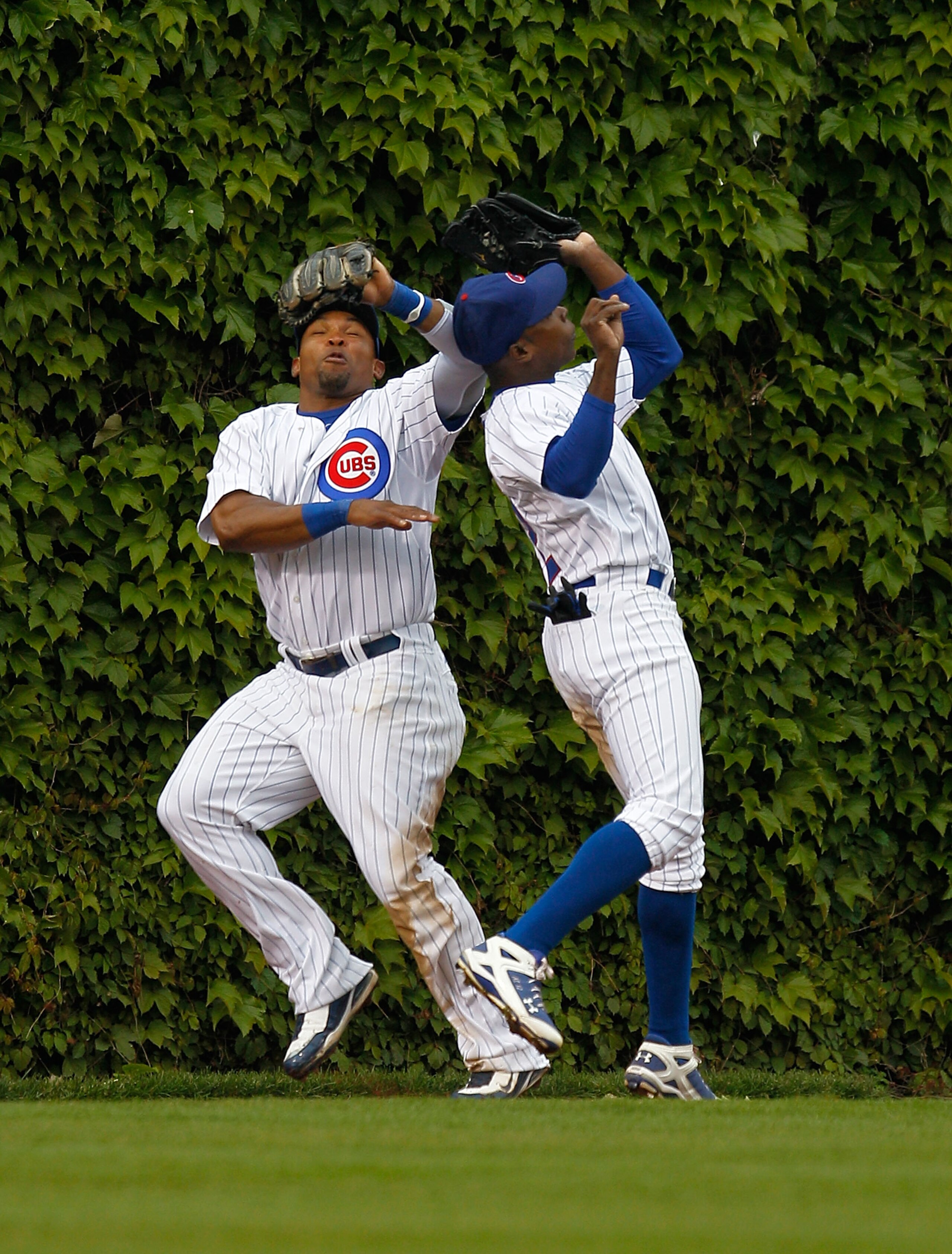 CHICAGO - MAY 12: Marlon Byrd #24 (L) and teammate Alfonso Soriano #12 of the Chicago Cubs avoid a collision in the outfield as Soriano makes the catch against the Florida Marlins at Wrigley Field on May 12, 2010 in Chicago, Illinois. (Photo by Jonathan D