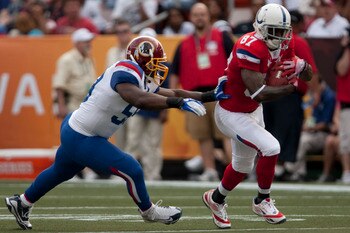 HONOLULU - JANUARY 30:  Reggie Wayne, #87 of the Indianapolis Colts, carries the ball while London Fletcher, #59 of the Washington Redskins, during the 2011 NFL Pro Bowl at Aloha Stadium on January 30, 2011 in Honolulu, Hawaii.  (Photo by Kent Nishimura/G