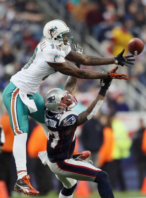 FOXBORO, MA - JANUARY 02:  Brandon Marshall #19 of the Miami Dolphins makes the catch as Kyle Arrington #27 of the New England Patriots defends on January 2, 2011 at Gillette Stadium in Foxboro, Massachusetts.  (Photo by Elsa/Getty Images)