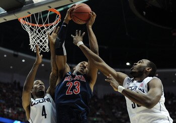 ANAHEIM, CA - MARCH 26:  Derrick Williams #23 of the Arizona Wildcats goes up for a rebound against Jamal Coombs-McDaniel #4 and Charles Okwandu #35 of the Connecticut Huskies during the west regional final of the 2011 NCAA men's basketball tournament at 
