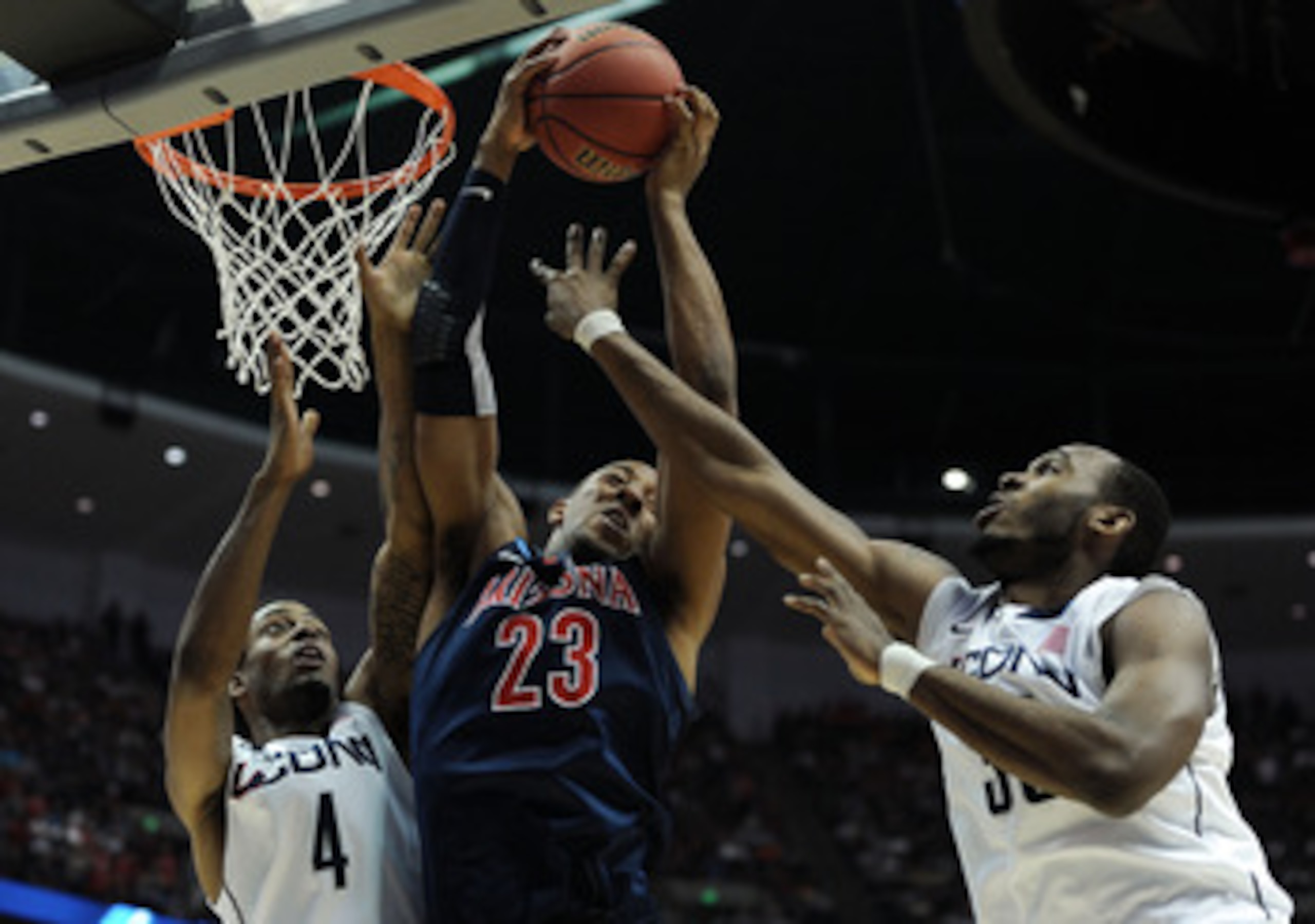 ANAHEIM, CA - MARCH 26: Derrick Williams #23 of the Arizona Wildcats goes up for a rebound against Jamal Coombs-McDaniel #4 and Charles Okwandu #35 of the Connecticut Huskies during the west regional final of the 2011 NCAA men's basketball tournament at ANAHEIM, CA - MARCH 26: Derrick Williams #23 of the Arizona Wildcats goes up for a rebound against Jamal Coombs-McDaniel #4 and Charles Okwandu #35 of the Connecticut Huskies during the west regional final of the 2011 NCAA men's basketball tournament at