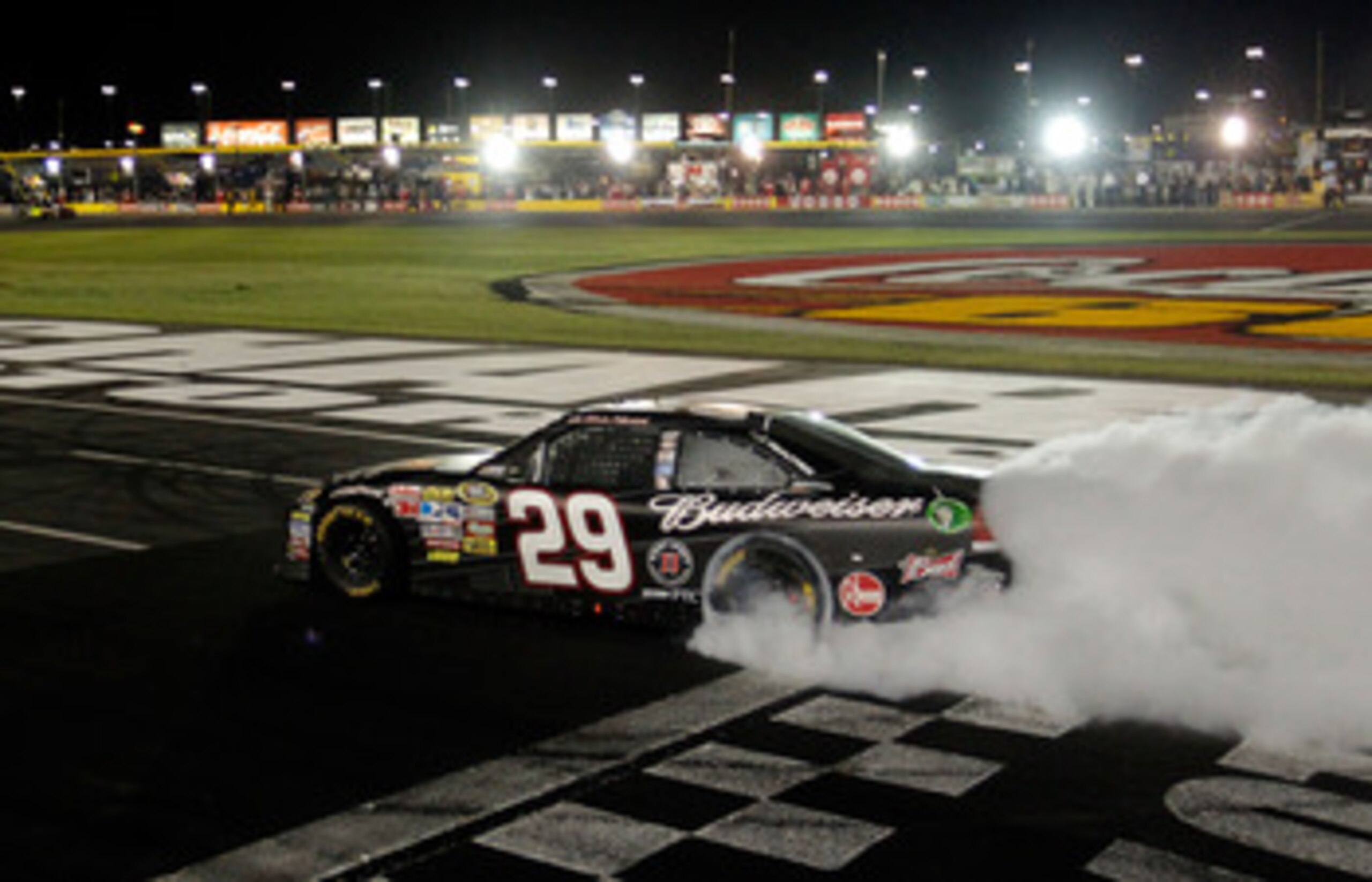 CONCORD, NC - MAY 29:  Kevin Harvick, driver of the #29 Budweiser Armed Forces Tribute Chevrolet, celebrates with a burnout after winning the NASCAR Sprint Cup Series Coca-Cola 600 at Charlotte Motor Speedway on May 29, 2011 in Concord, North Carolina.  (