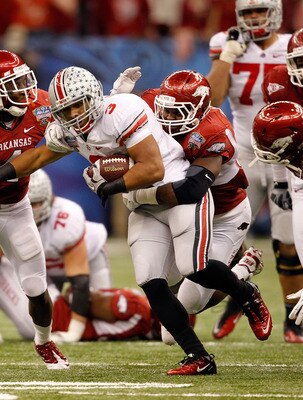 NEW ORLEANS, LA - JANUARY 04:  Brandon Saine #3 of the Ohio State Buckeyes makes a move after a catch against Jerry Franklin #34 of the Arkansas Razorbacks during the Allstate Sugar Bowl at the Louisiana Superdome on January 4, 2011 in New Orleans, Louisi