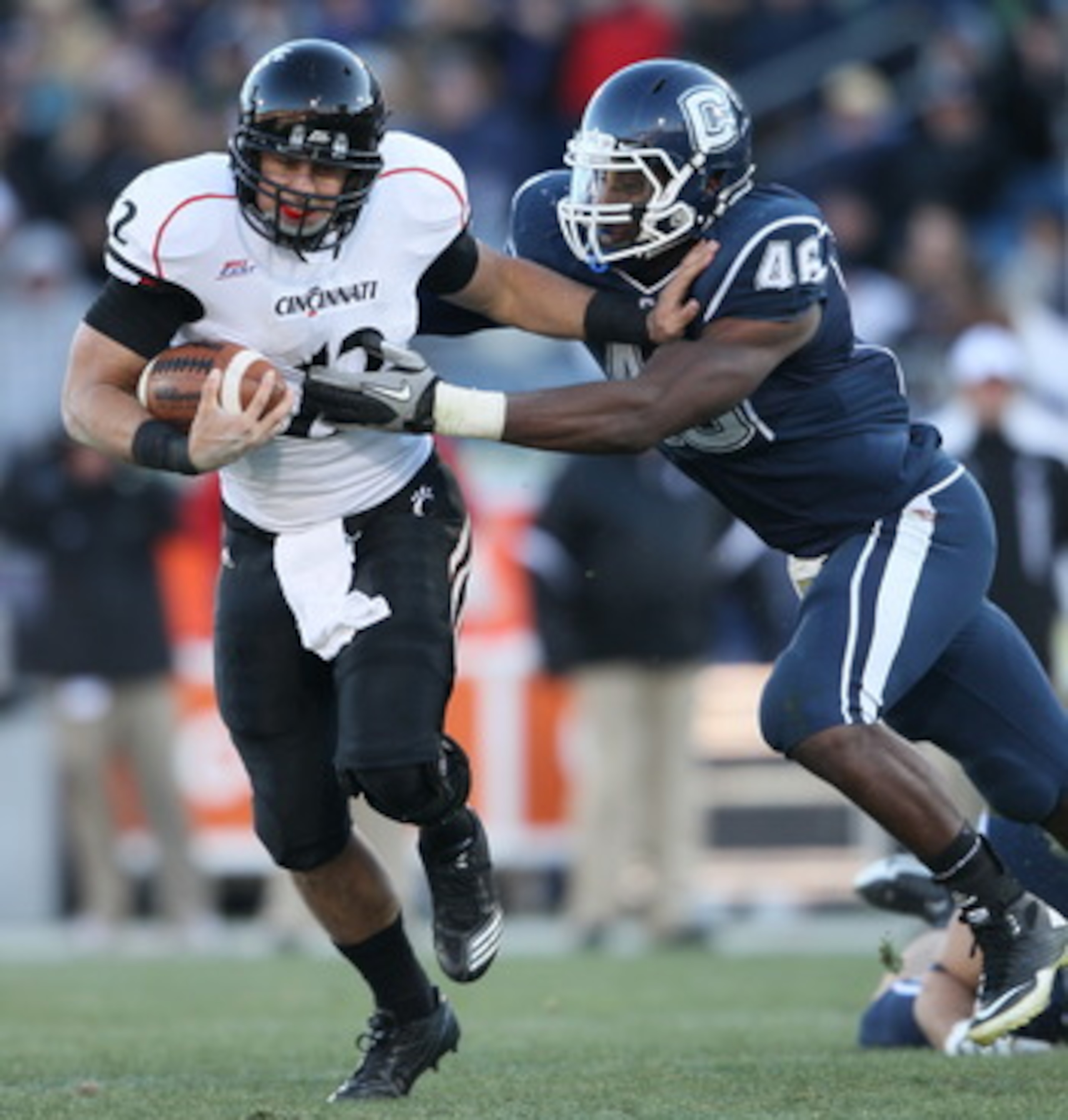 EAST HARTFORD, CT - NOVEMBER 27: Zach Collaros #12 of the Cincinnati Bearcats carries the ball as Sio Moore #46 of the Connecticut Huskies makes the tackle on November 27, 2010 at Rentschler Field in East Hartford, Connecticut. The Huskies defeated the B EAST HARTFORD, CT - NOVEMBER 27: Zach Collaros #12 of the Cincinnati Bearcats carries the ball as Sio Moore #46 of the Connecticut Huskies makes the tackle on November 27, 2010 at Rentschler Field in East Hartford, Connecticut. The Huskies defeated the B