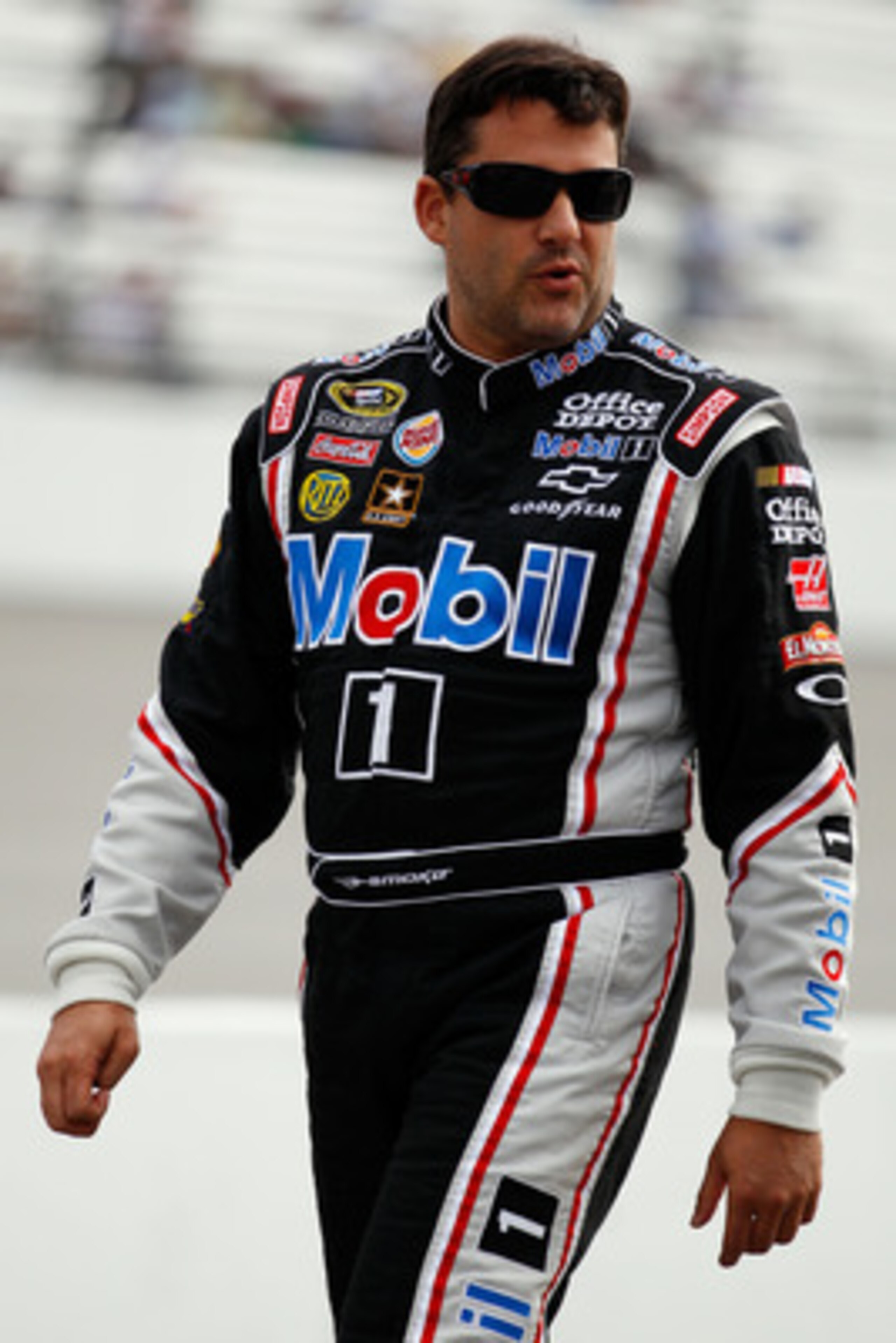 RICHMOND, VA - APRIL 29:  Tony Stewart, driver of the #14 Mobil 1/Office Depot Chevrolet, walks on pit road during qualifying for the NASCAR Sprint Cup Series Crown Royal Presents The Matthew & Daniel Hansen 400 at Richmond International Raceway on April 