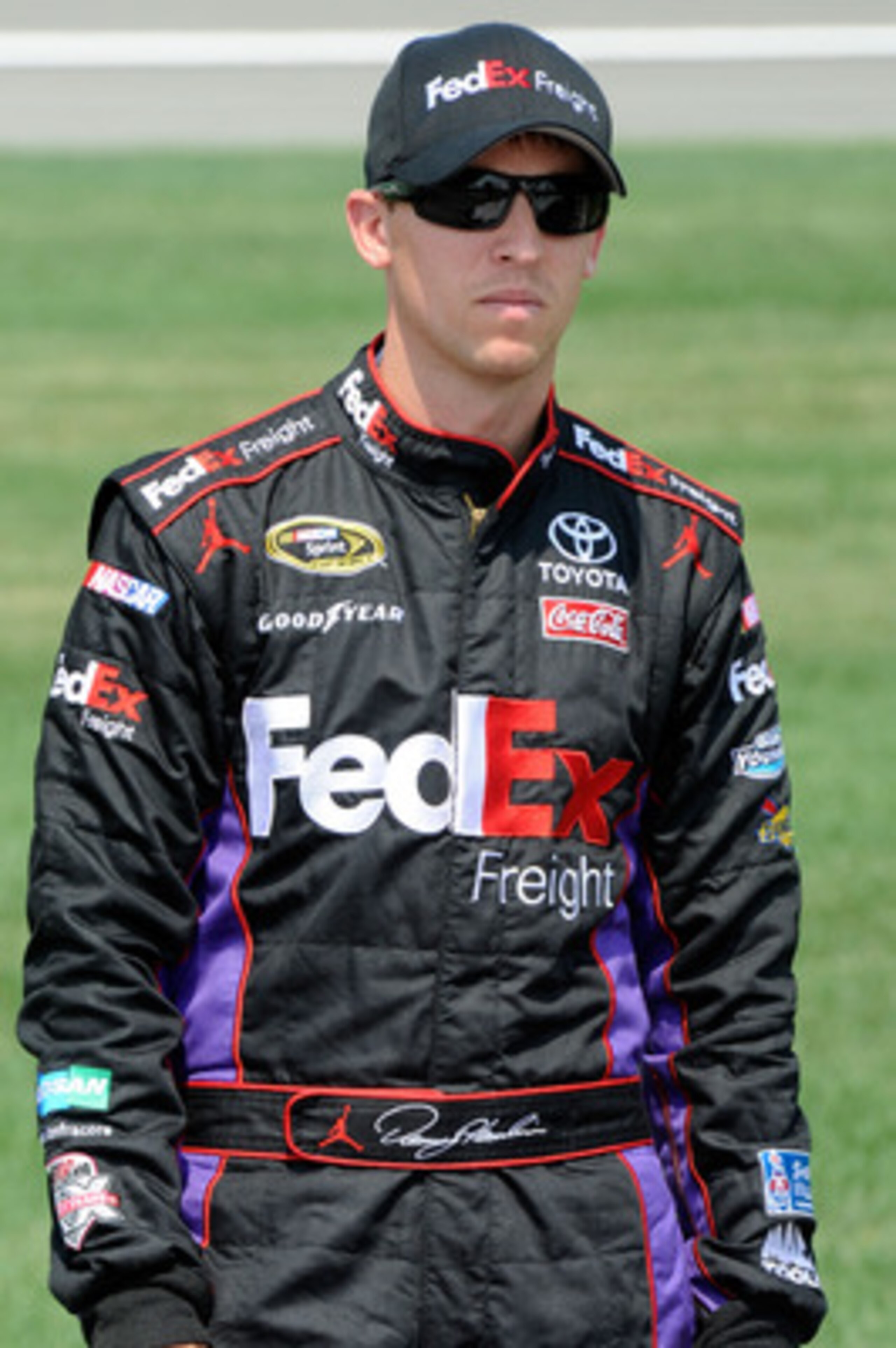 KANSAS CITY, KS - JUNE 04:  Denny Hamlin, driver of the #11 FedEx Freight Toyota, stands on the grid during qualifying for the NASCAR Sprint Cup Series STP 400 at Kansas Speedway on June 4, 2011 in Kansas City, Kansas.  (Photo by John Harrelson/Getty Imag