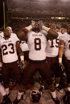 AUSTIN, TX - NOVEMBER 25:  Texas A&M players (L-R) Dustin Harris #22, Ben Malena #23, Jeff Fuller #8, Michael Lamothe #19, Blane Cheatham #29, and C.J. Jones #27 celebrate Texas A&M's 24-17 win over the University of Texas at Darrell K. Royal-Texas Memori