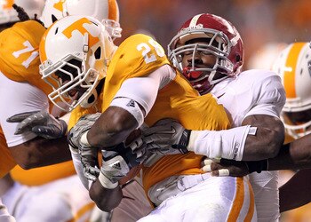 KNOXVILLE, TN - OCTOBER 23:  Tauren Poole #28 of the Tennessee Volunteers runs with the ball dwhile tackled by C.J. Mosley #32 of the Alabama Crimson Tide at Neyland Stadium on October 23, 2010 in Knoxville, Tennessee.  (Photo by Andy Lyons/Getty Images)