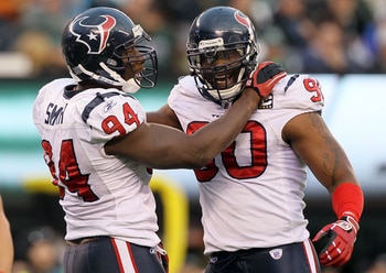 EAST RUTHERFORD, NJ - NOVEMBER 21: Mario Williams #90 of the Houston Texans celebrates a sack against the New York Jets with teammate Antonio Smith #94 on November 21, 2010 at the New Meadowlands Stadium in East Rutherford, New Jersey. The Jets defeated t