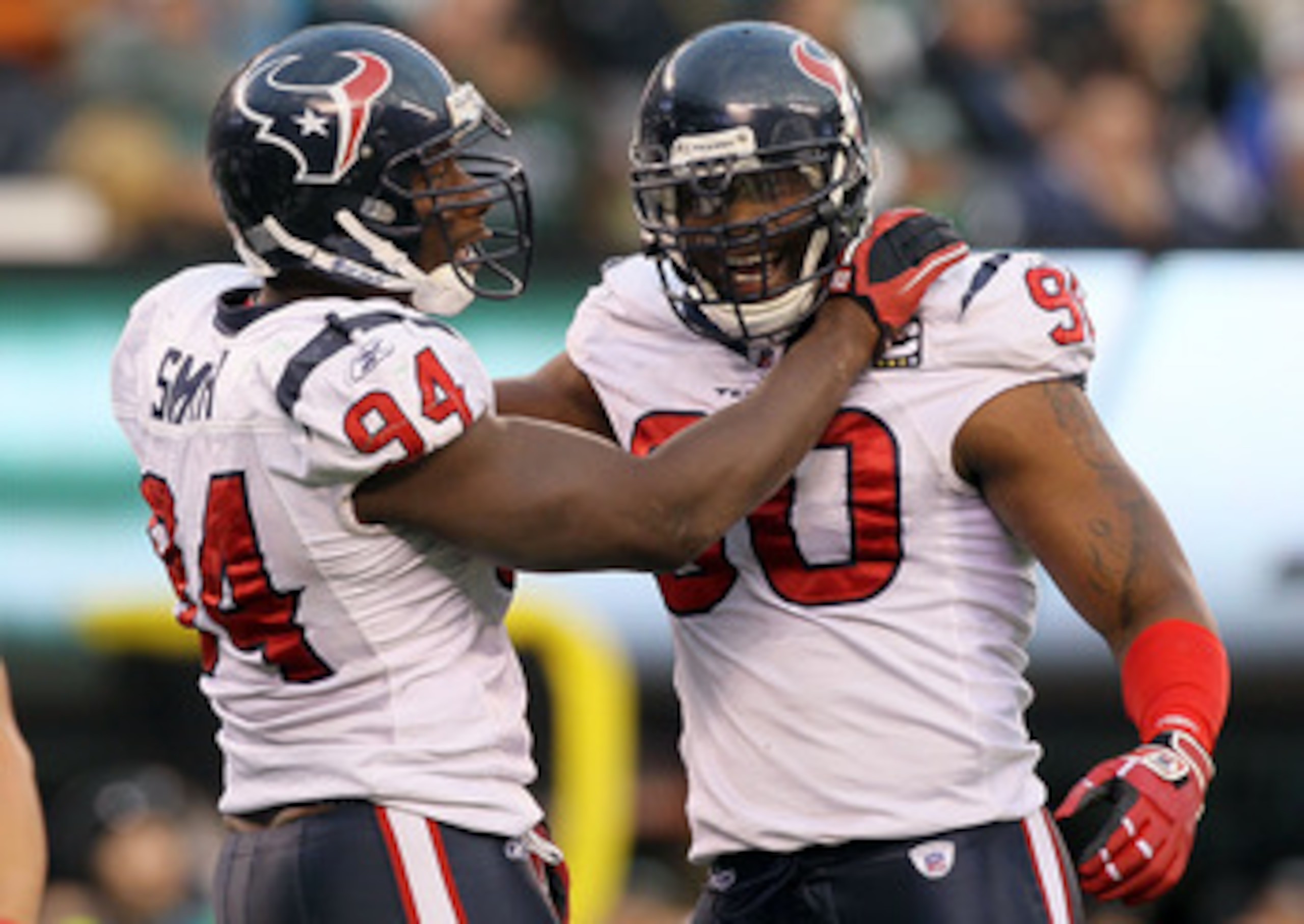 EAST RUTHERFORD, NJ - NOVEMBER 21: Mario Williams #90 of the Houston Texans celebrates a sack against the New York Jets with teammate Antonio Smith #94 on November 21, 2010 at the New Meadowlands Stadium in East Rutherford, New Jersey. The Jets defeated t