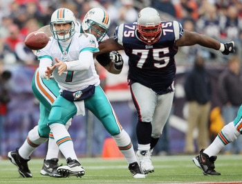FOXBORO, MA - JANUARY 02:  Chad Henne #7 of the Miami Dolphins pitches the ball as Vince Wilfork #75 of the New England Patriots closes in on January 2, 2011 at Gillette Stadium in Foxboro, Massachusetts.  (Photo by Elsa/Getty Images)