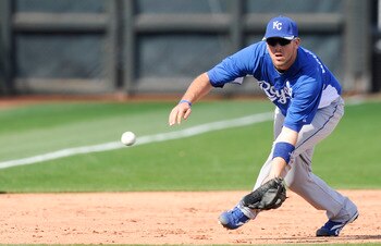 SURPISE, AZ - FEBRUARY 27: Mike Moustakas #8 of the Kansas City Royals field a ground ball during a spring training game against the Texas Rangers at Surprise Stadium on February 27, 2011 in Surprise, Arizona. (Photo by Rob Tringali/Getty Images)