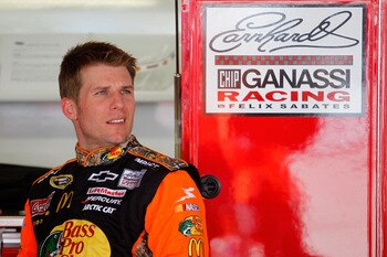 DOVER, DE - MAY 13:  Jamie McMurray, driver of the #1 Bass Pro Shops/Tracker Chevrolet, stands in the garage during practice for the NASCAR Sprint Cup Series FedEx 400 Benefiting Autism Speaks at Dover International Speedway on May 13, 2011 in Dover, Dela