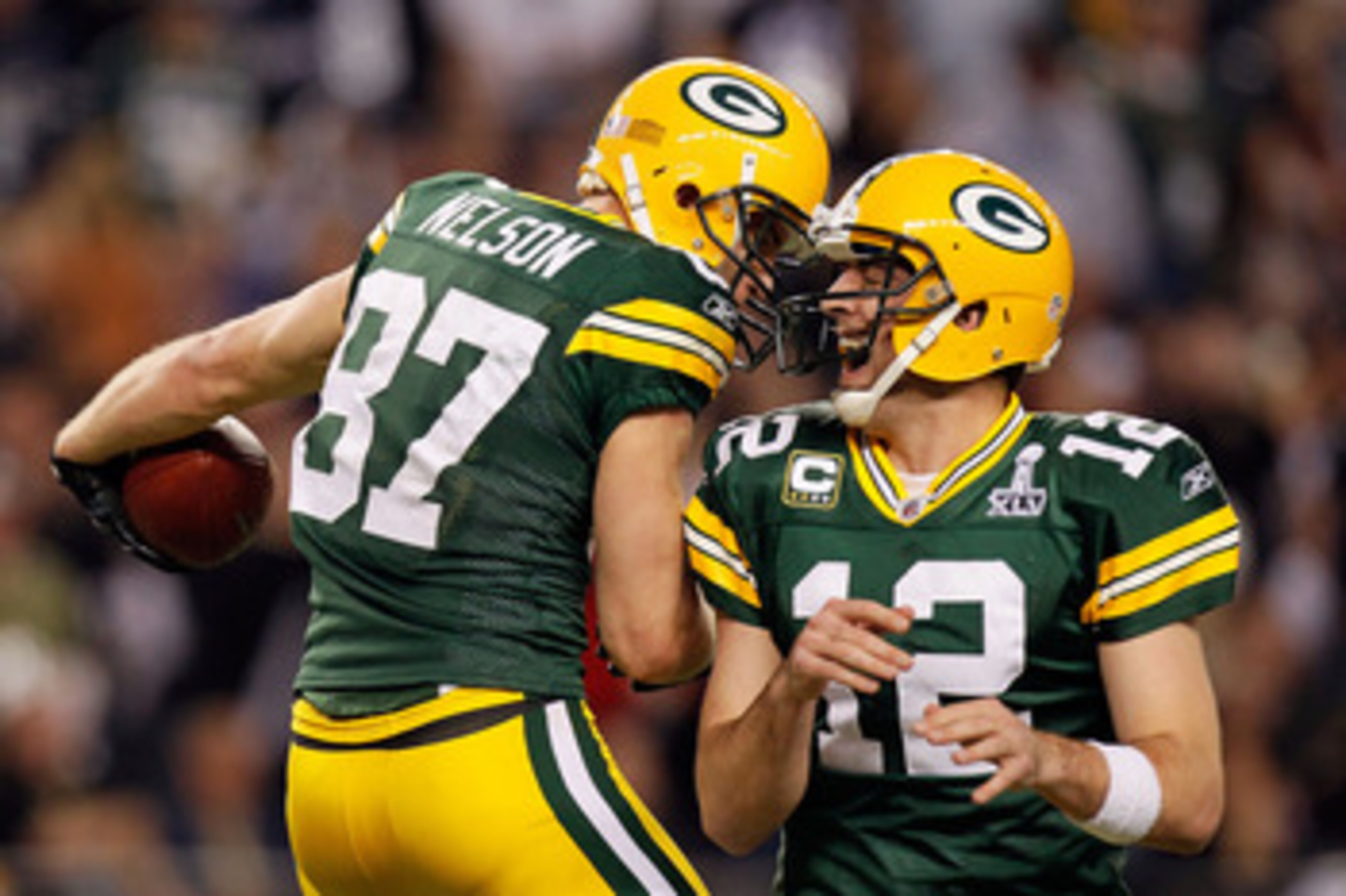ARLINGTON, TX - FEBRUARY 06:  Jordy Nelson #87 and Aaron Rodgers #12 of the Green Bay Packers celebrate after a 29 yard touchdown pass against the Pittsburgh Steelers during Super Bowl XLV at Cowboys Stadium on February 6, 2011 in Arlington, Texas.  (Phot
