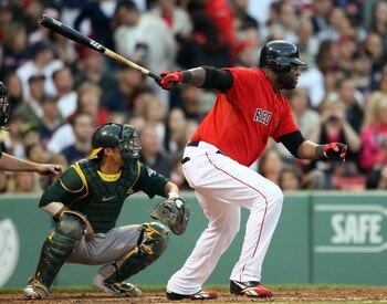 BOSTON, MA - JUNE 03:  David Ortiz #34 of the Boston Red Sox gets a hit in the first inning as Kurt Suzuki #8 of the Oakland Athletics defends on June 3, 2011 at Fenway Park in Boston, Massachusetts.  (Photo by Elsa/Getty Images)