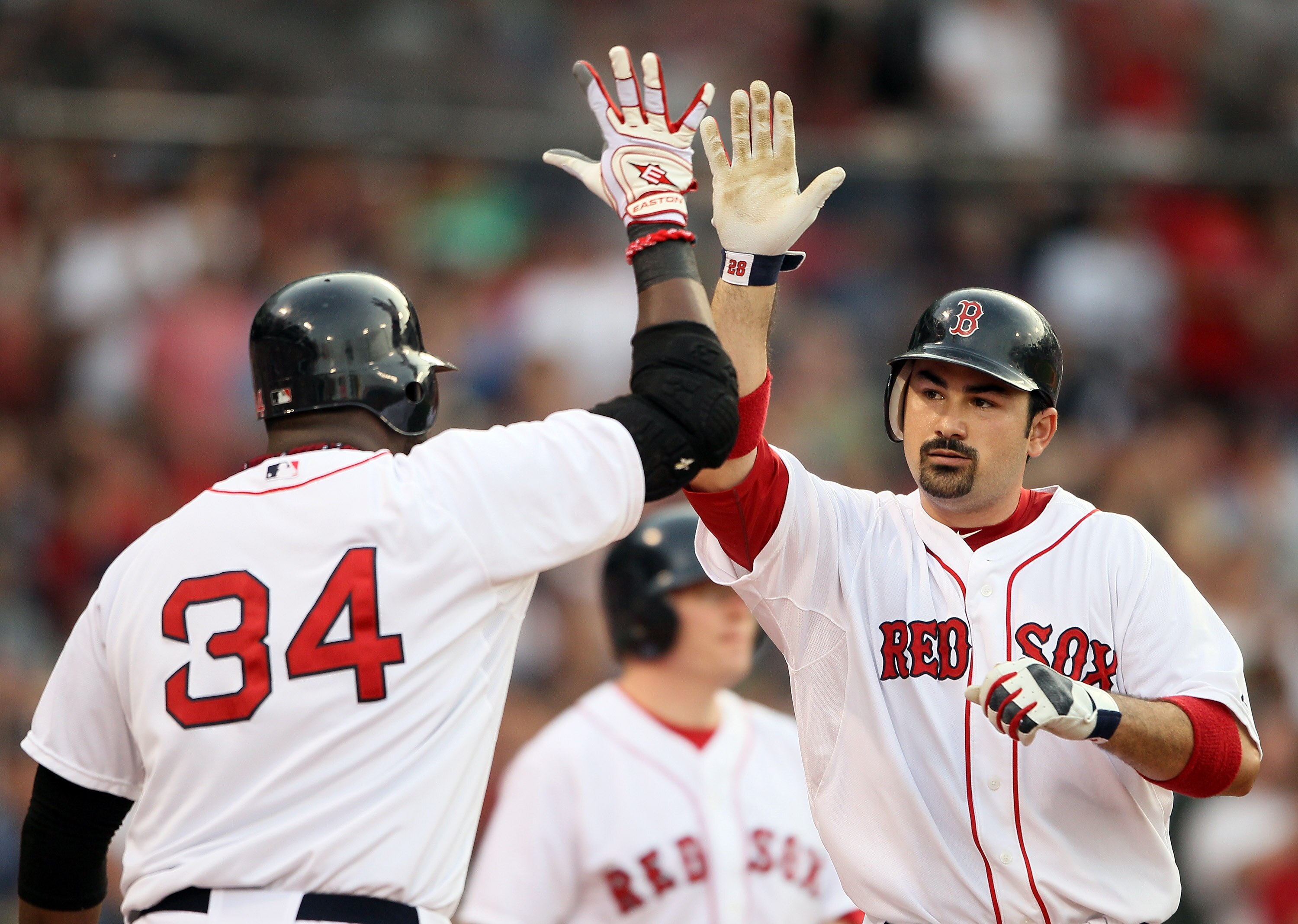 BOSTON, MA - MAY 30: Adrian Gonzalez #28 of the Boston Red Sox is congratulated by teammate David Ortiz #34 after Gonzalez hits a a solo home run in the first inning against the Chicago White Sox on May 30, 2011 at Fenway Park in Boston, Massachusetts. BOSTON, MA - MAY 30: Adrian Gonzalez #28 of the Boston Red Sox is congratulated by teammate David Ortiz #34 after Gonzalez hits a a solo home run in the first inning against the Chicago White Sox on May 30, 2011 at Fenway Park in Boston, Massachusetts.
