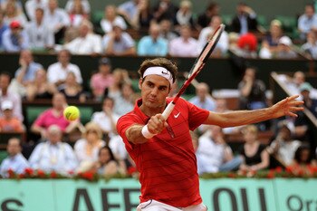 PARIS, FRANCE - JUNE 03:  Roger Federer of Switzerland hits a backhand during the men's singles semi final match between Roger Federer of Switzerland and Novak Djokovic of Serbia on day thirteen of the French Open at Roland Garros on June 3, 2011 in Paris