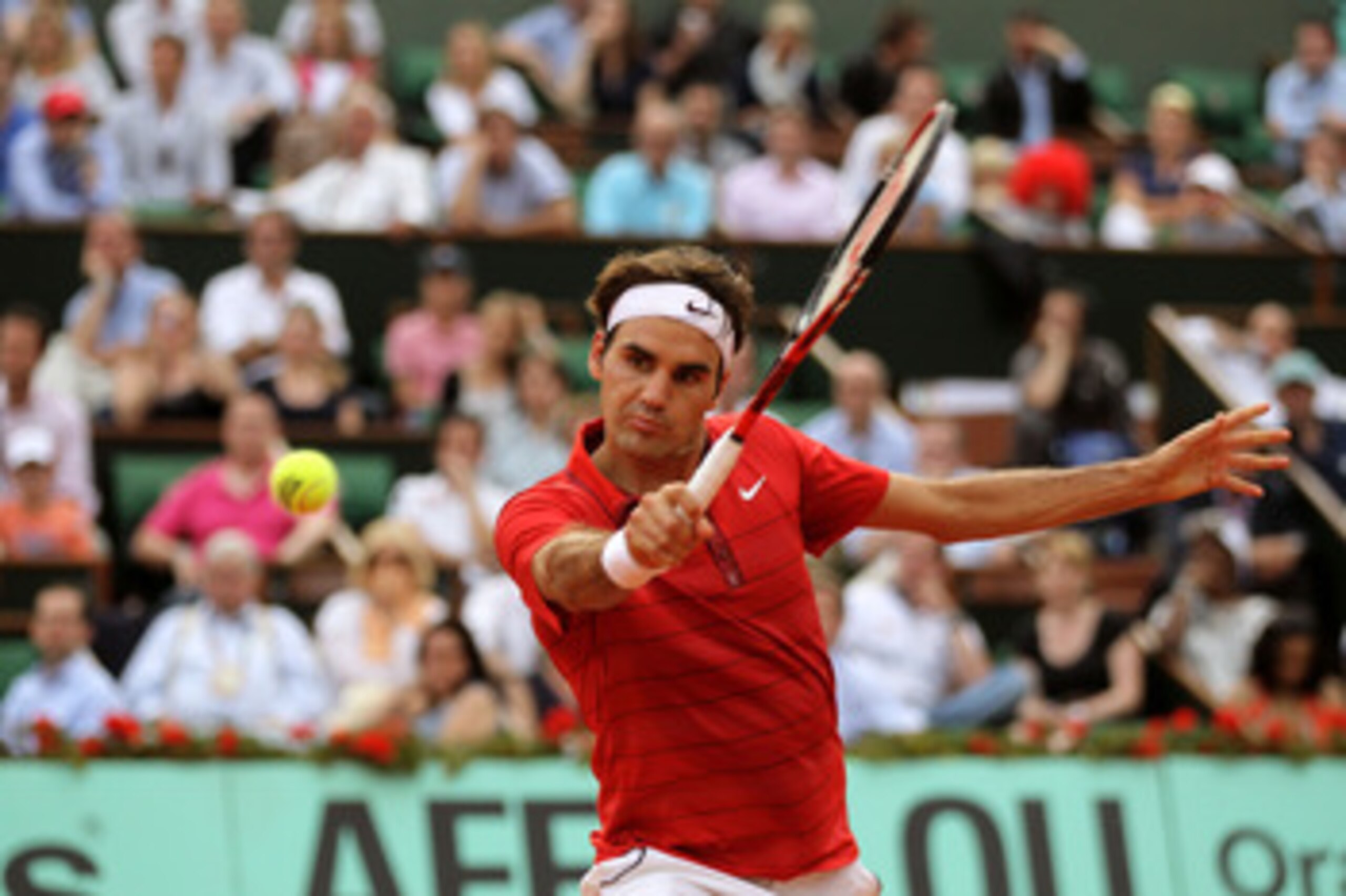 PARIS, FRANCE - JUNE 03:  Roger Federer of Switzerland hits a backhand during the men's singles semi final match between Roger Federer of Switzerland and Novak Djokovic of Serbia on day thirteen of the French Open at Roland Garros on June 3, 2011 in Paris