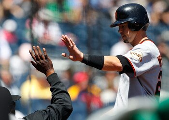 PITTSBURGH - APRIL 28: Eli Whiteside #22 of the San Francisco Giants is congratulated by teammates in the dugout after scoring against the Pittsburgh Pirates during the game on April 28, 2011 at PNC Park in Pittsburgh, Pennsylvania.  (Photo by Jared Wicke