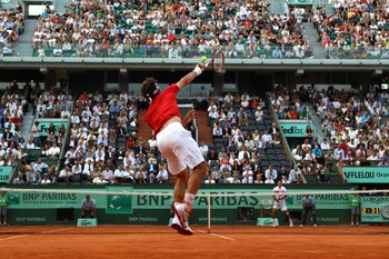 PARIS, FRANCE - JUNE 03:  Roger Federer of Switzerland serves during the men's singles semi final match between Roger Federer of Switzerland and Novak Djokovic of Serbia on day thirteen of the French Open at Roland Garros on June 3, 2011 in Paris, France.