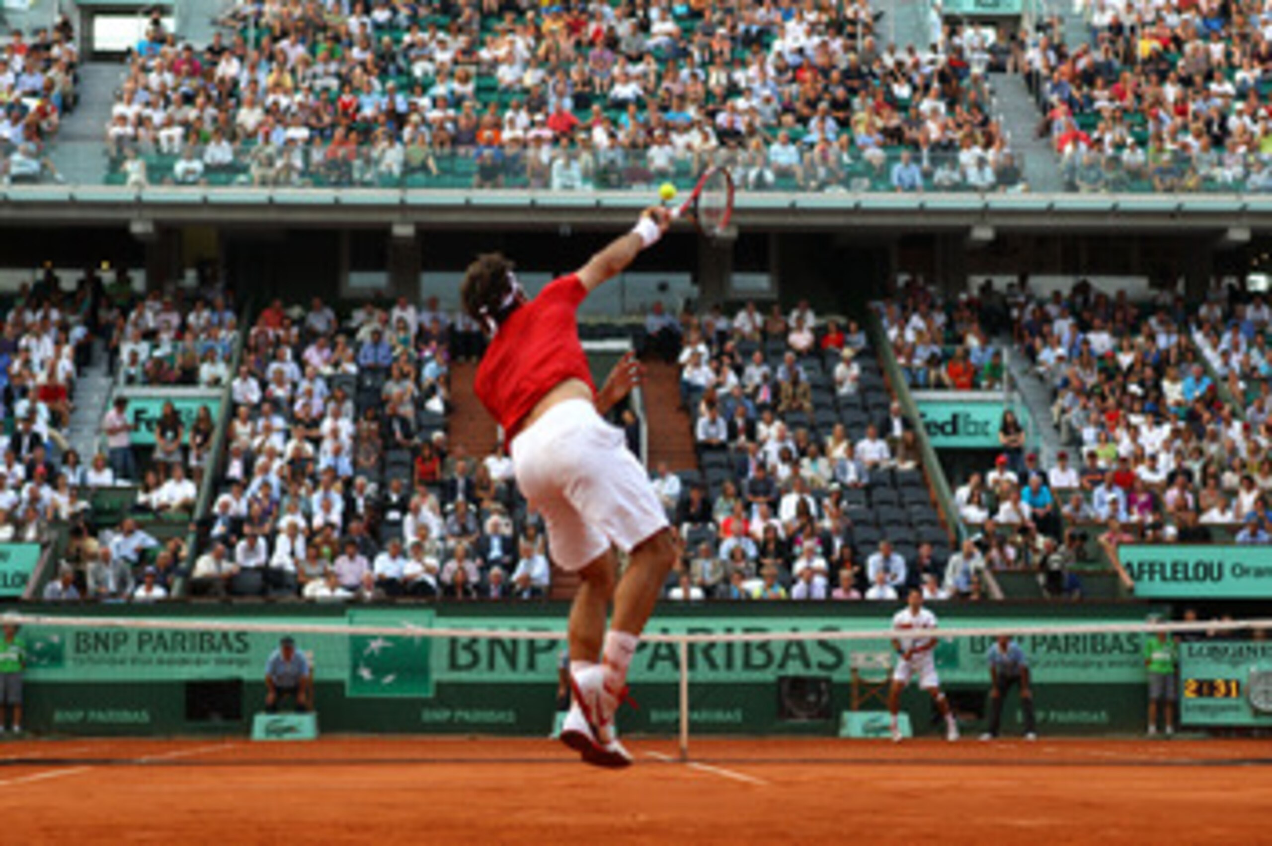 PARIS, FRANCE - JUNE 03:  Roger Federer of Switzerland serves during the men's singles semi final match between Roger Federer of Switzerland and Novak Djokovic of Serbia on day thirteen of the French Open at Roland Garros on June 3, 2011 in Paris, France.