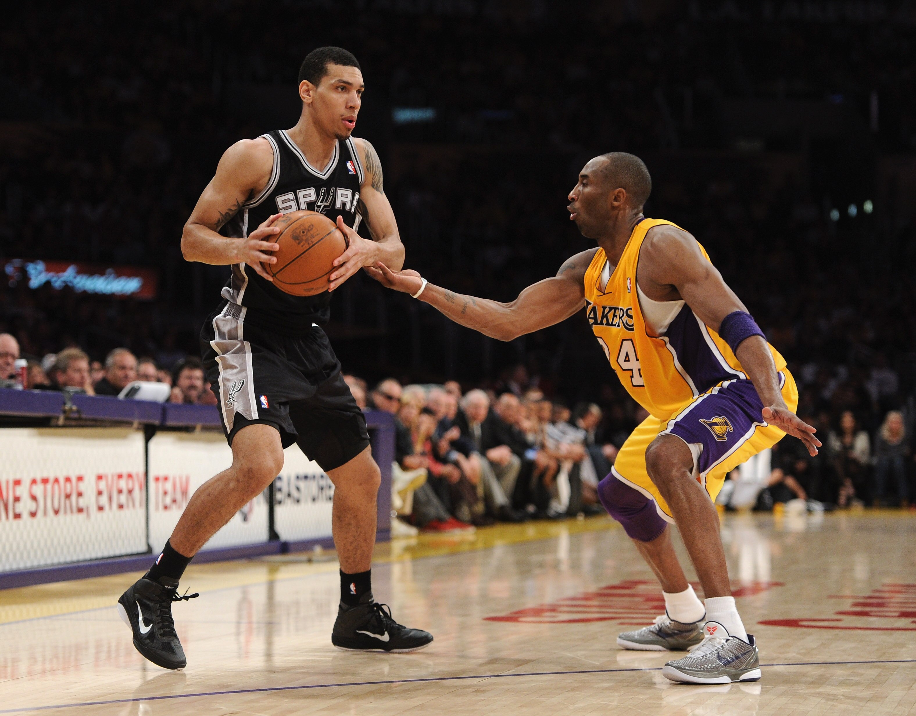 LOS ANGELES, CA - APRIL 12:  Danny Green #4 of the San Antonio Spurs looks to pass in front of Kobe Bryant #23 of the Los Angeles Lakers at Staples Center on April 12, 2011 in Los Angeles, California.  NOTE TO USER: User expressly acknowledges and agrees