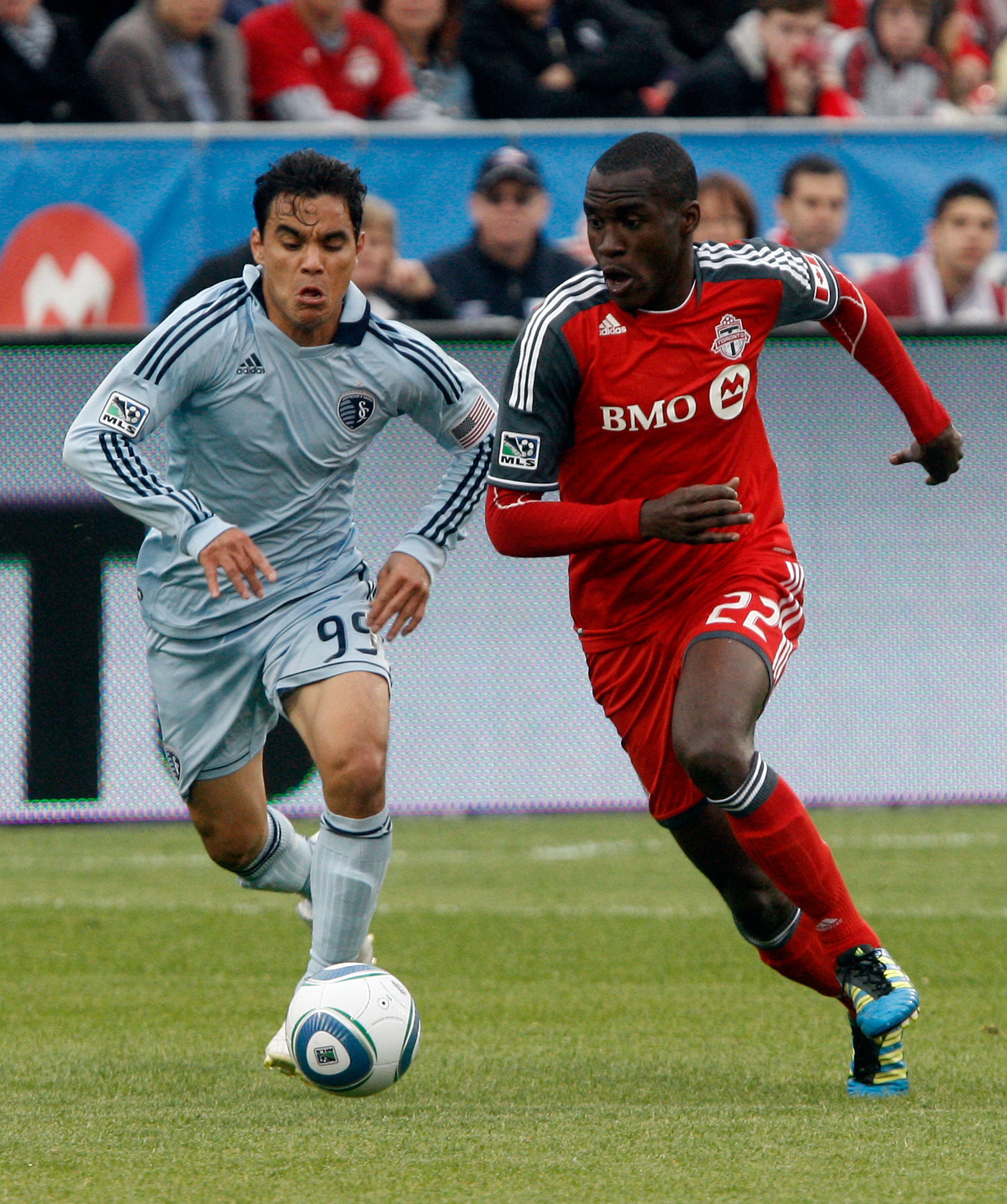TORONTO, CANADA - JUNE 4:  Tony Tchani #22 of Toronto FC battles for the ball with Omar Bravo #99 of Sporting Kansas City during MLS action at BMO Field June 4, 2011 in Toronto, Ontario, Canada. (Photo by Abelimages/Getty Images)