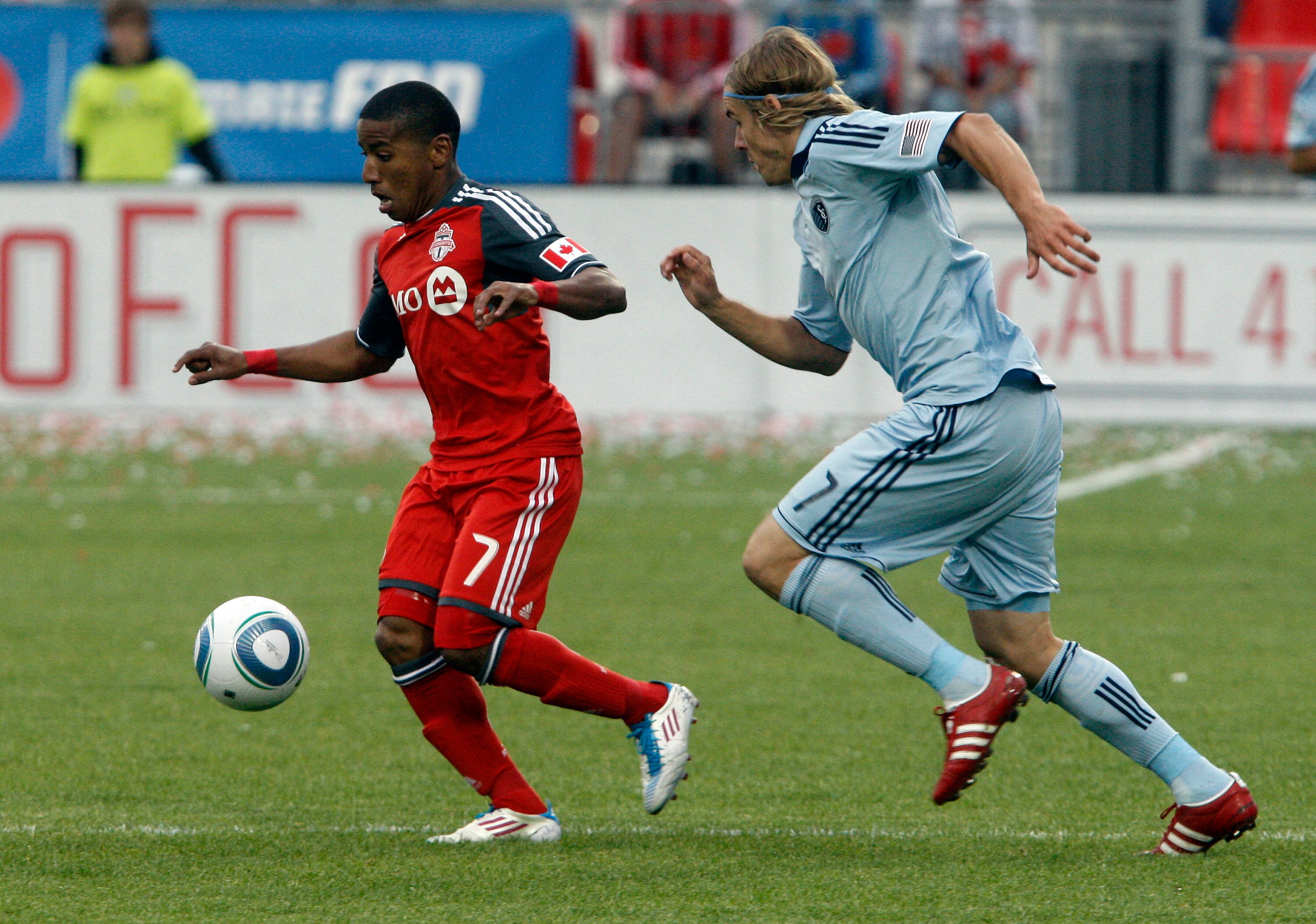 TORONTO, CANADA - JUNE 4:  Joao Plata #7 of Toronto FC gets around Chance Myers #7 of Sporting Kansas City during MLS action at BMO Field June 4, 2011 in Toronto, Ontario, Canada. (Photo by Abelimages/Getty Images)