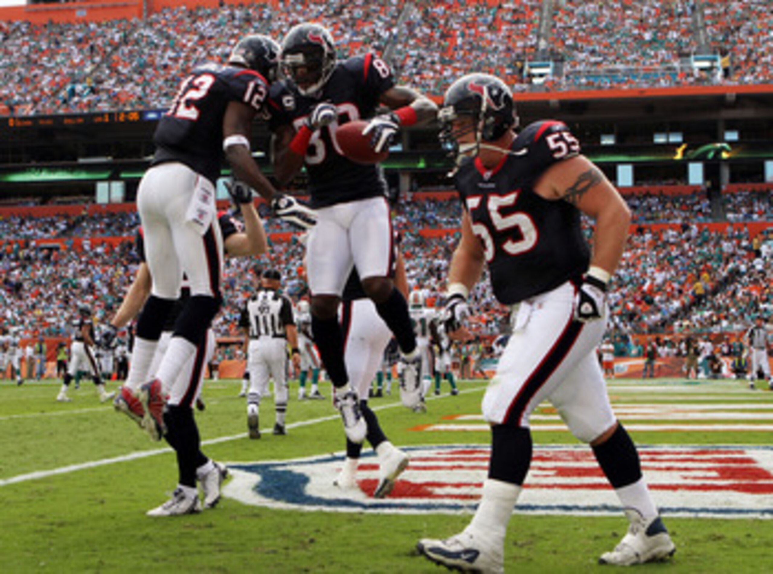 MIAMI - DECEMBER 27:  Wide receivers Andre Johnson #80 and Jacoby Jones #12 of the Houston Texans after Johnson scored a touchdown against the Miami Dolphins at Land Shark Stadium on December 27, 2009 in Miami, Florida. The Texans defeated the Dolphins 27