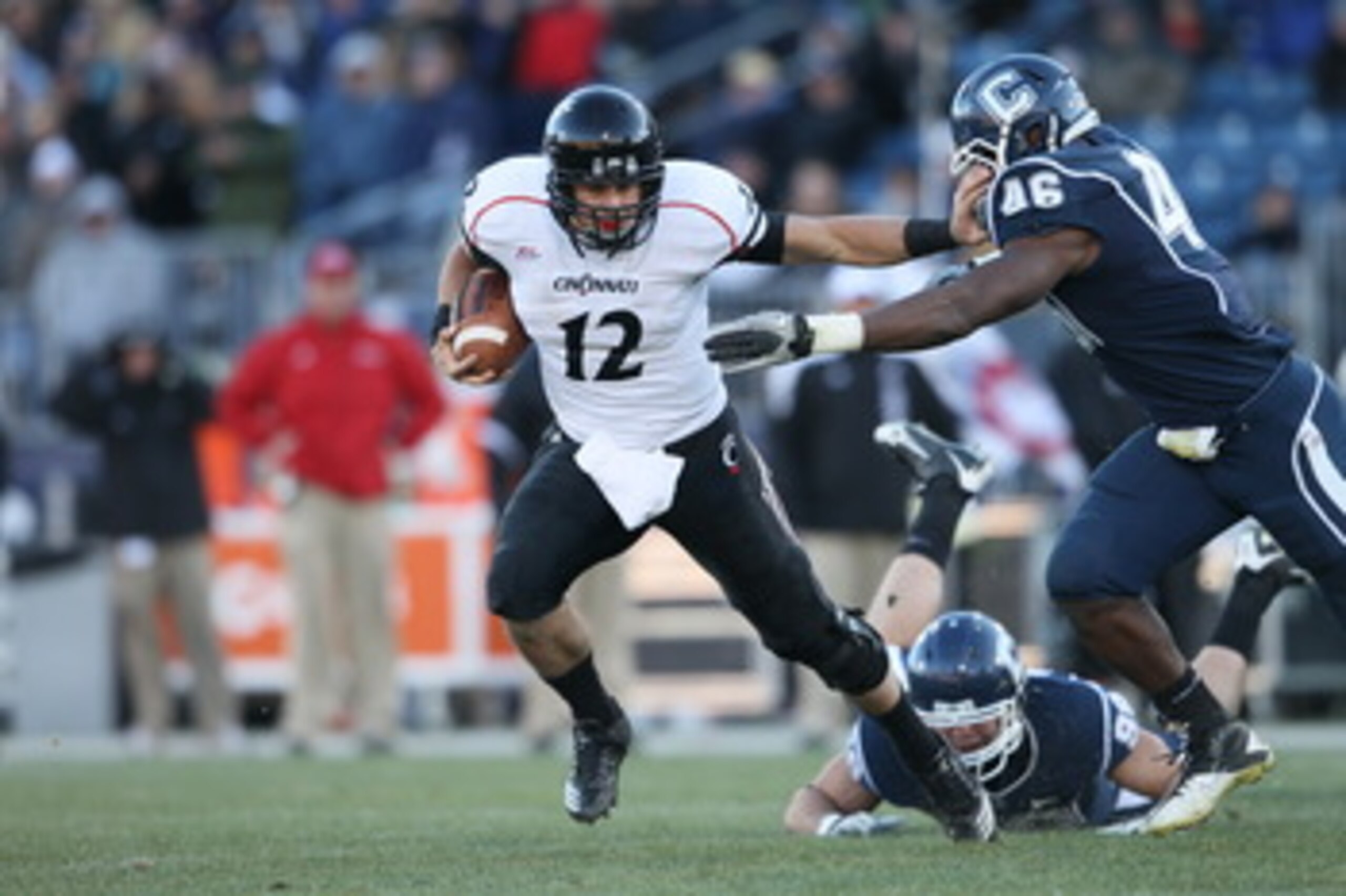 EAST HARTFORD, CT - NOVEMBER 27: Zach Collaros #12 of the Cincinnati Bearcats carries the ball as Sio Moore #46 of the Connecticut Huskies makes the tackle on November 27, 2010 at Rentschler Field in East Hartford, Connecticut. The Huskies defeated the B EAST HARTFORD, CT - NOVEMBER 27: Zach Collaros #12 of the Cincinnati Bearcats carries the ball as Sio Moore #46 of the Connecticut Huskies makes the tackle on November 27, 2010 at Rentschler Field in East Hartford, Connecticut. The Huskies defeated the B