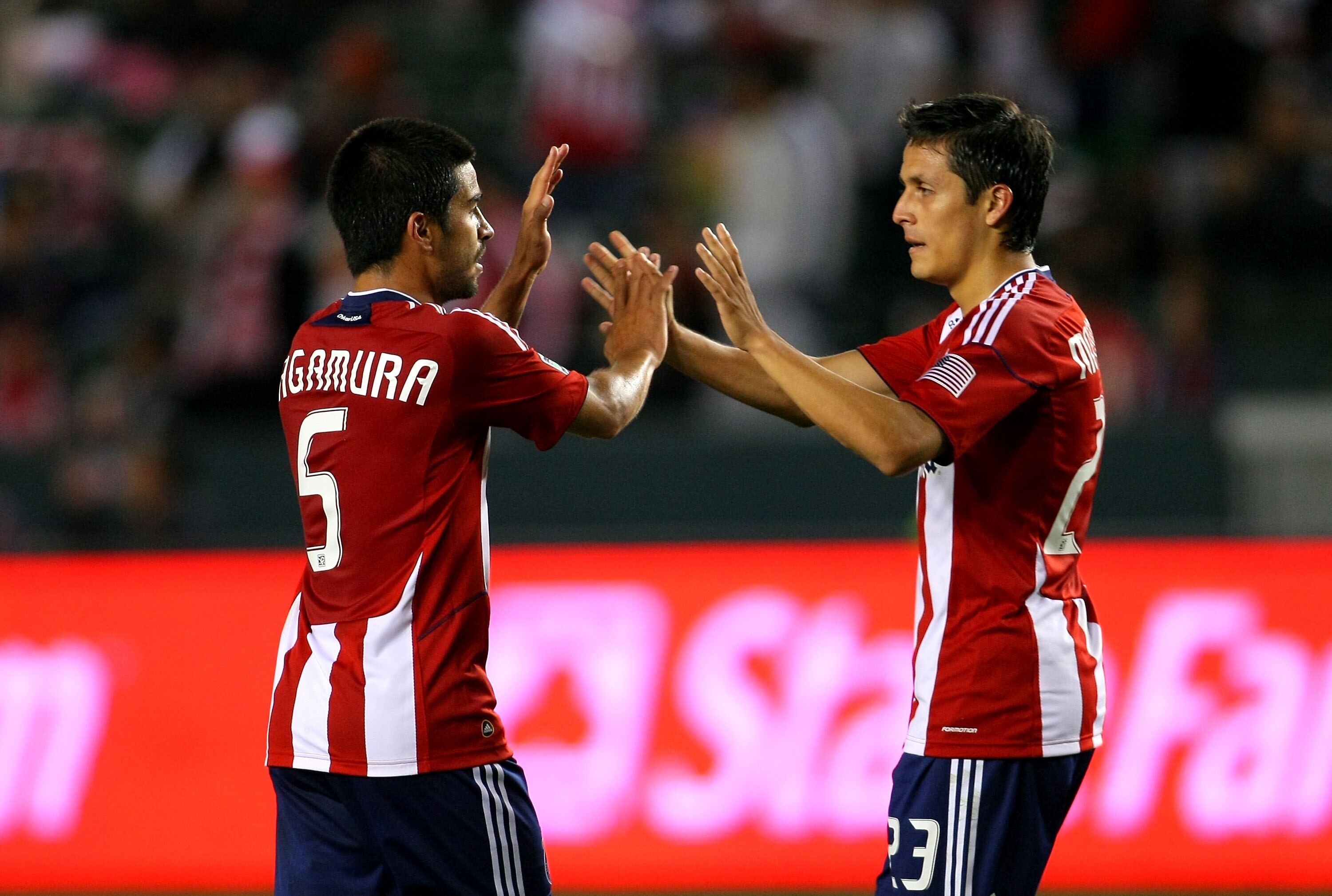 CARSON, CA - JUNE 04:  Paulo Nagamura #5 of Chivas USA congratulates teammate Marcos Mondaini #23 after Mondaini scored the eventual game-winning goal in the second half during the MLS match against the Portland Timbers at The Home Depot Center on June 4,
