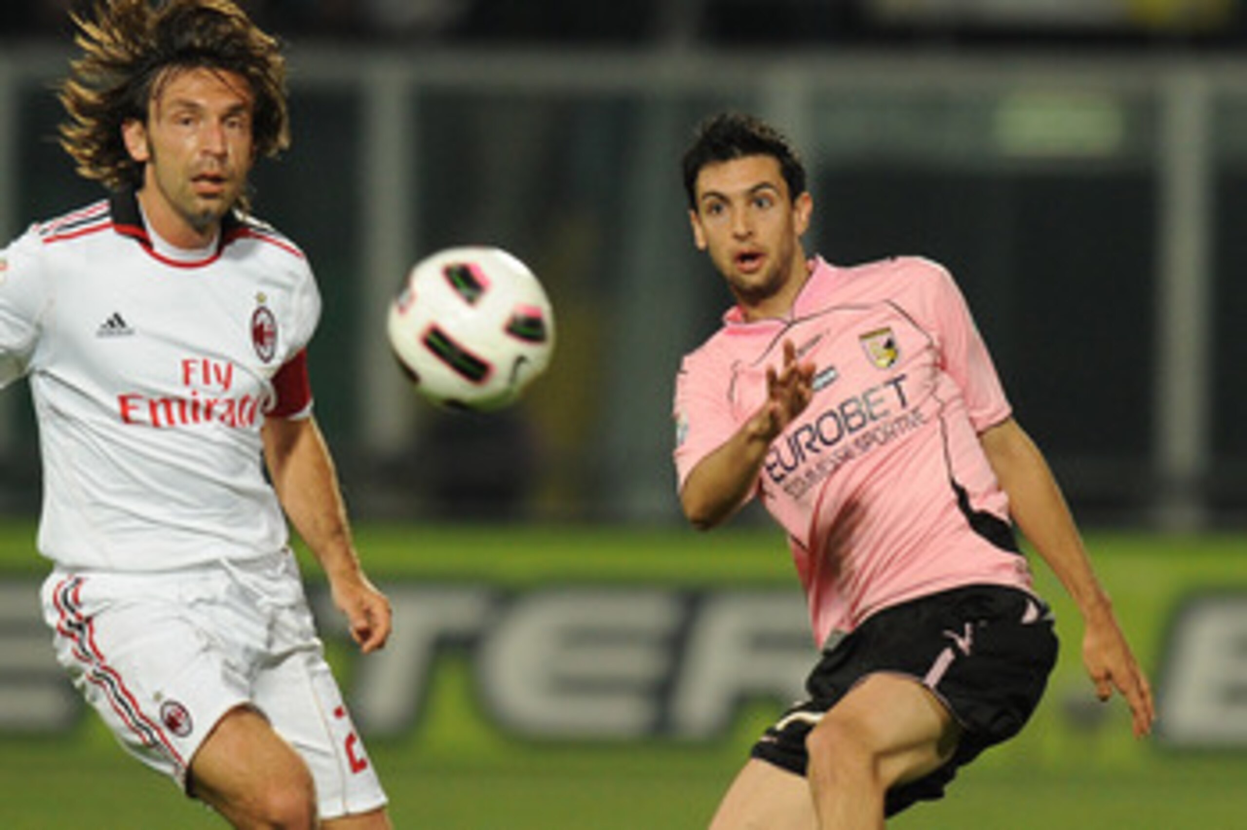 PALERMO, ITALY - MAY 10:  Javier Pastore (R) of Palermo and Andrea Pirlo of Palermo compete for the ball during the Tim Cup between US Citta di Palermo and AC Milan at Stadio Renzo Barbera on May 10, 2011 in Palermo, Italy.  (Photo by Tullio M. Puglia/Get