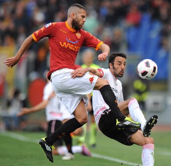 ROME, ITALY - APRIL 16:  Jeremy Menez (L) of Roma and Mattia Cassani of Palermo compete for the ball during the Serie A match between AS Roma and US Citta di Palermo at Stadio Olimpico on April 16, 2011 in Rome, Italy.  (Photo by Tullio M. Puglia/Getty Im