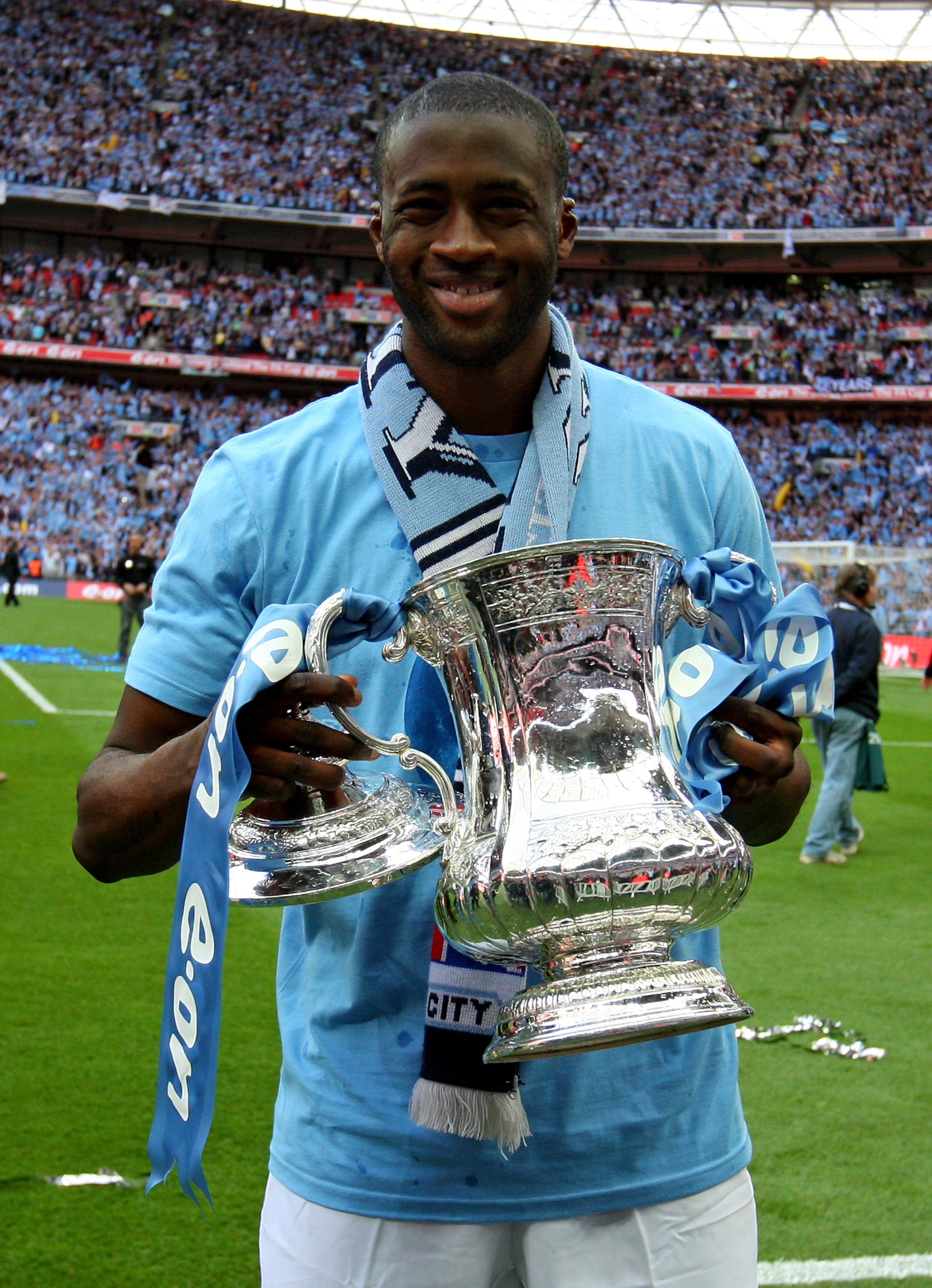 LONDON, ENGLAND - MAY 14:  Yaya Toure holds the trophy after he and his Manchester City team mates won the FA Cup sponsored by E.ON Final match between Manchester City and Stoke City at Wembley Stadium on May 14, 2011 in London, England.  (Photo by Alex L