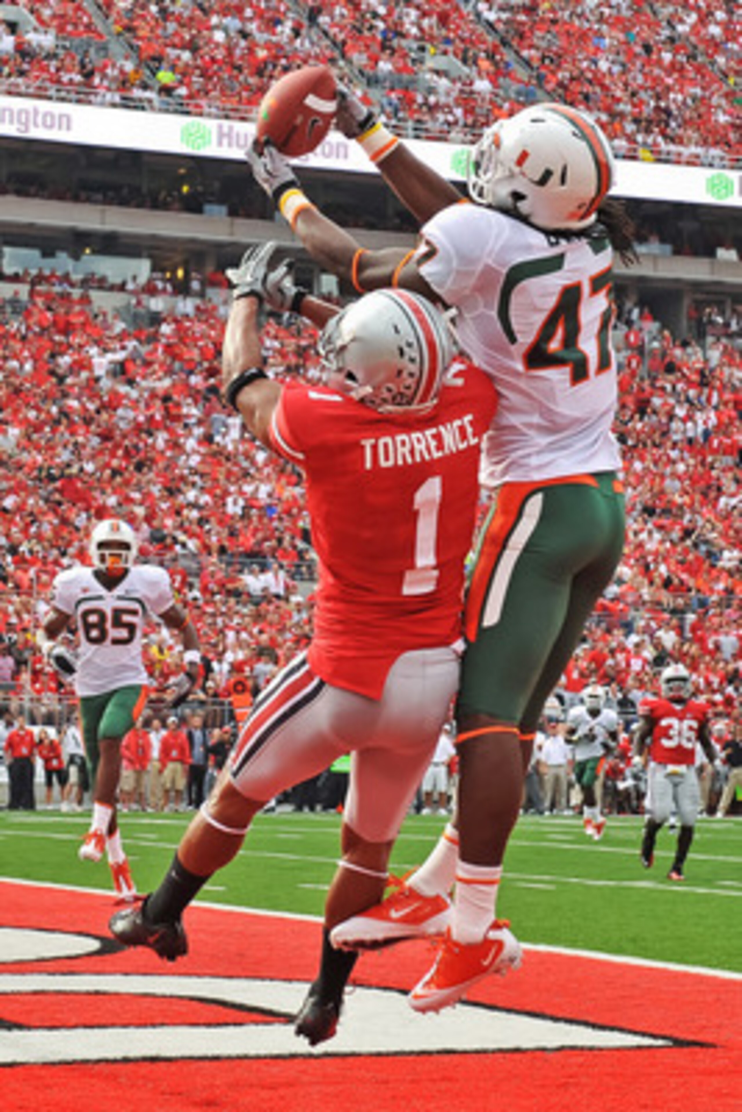 COLUMBUS, OH - SEPTEMBER 11:  LaRon Byrd #47 of the Miami Hurricanes attempts to catch a pass as Devon Torrence #1 of the Ohio State Buckeyes defends at Ohio Stadium on September 11, 2010 in Columbus, Ohio.  (Photo by Jamie Sabau/Getty Images)