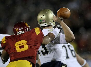 LOS ANGELES - NOVEMBER 27:  Defensive end Nick Perry #6 of the USC Trojans forces a fumble by quarterback Tommy Rees #13 of the Notre Dame Fighting Irish to set up USC's touchdown at the Los Angeles Memorial Coliseum on November 27, 2010 in Los Angeles, C