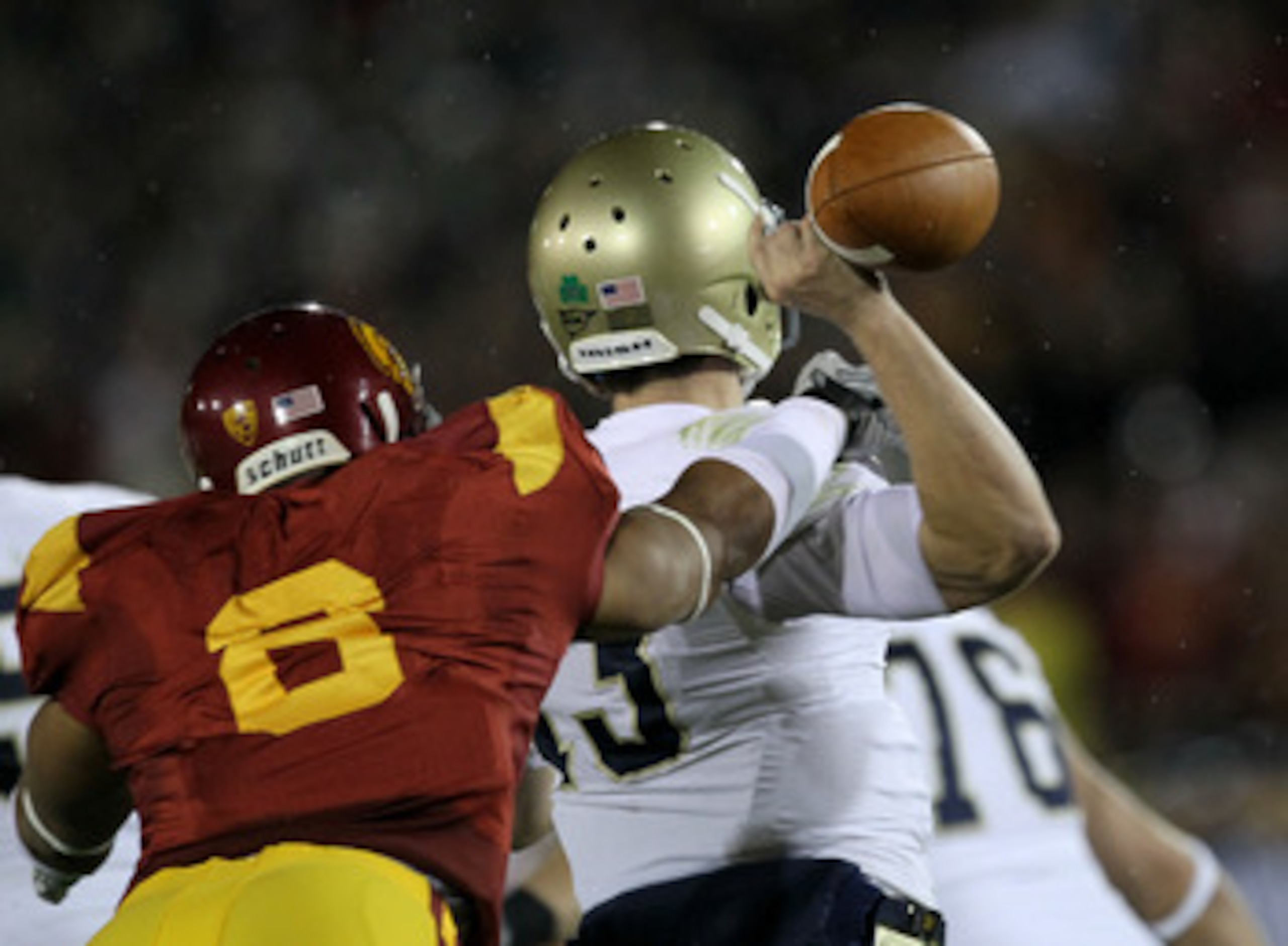 LOS ANGELES - NOVEMBER 27:  Defensive end Nick Perry #6 of the USC Trojans forces a fumble by quarterback Tommy Rees #13 of the Notre Dame Fighting Irish to set up USC's touchdown at the Los Angeles Memorial Coliseum on November 27, 2010 in Los Angeles, C