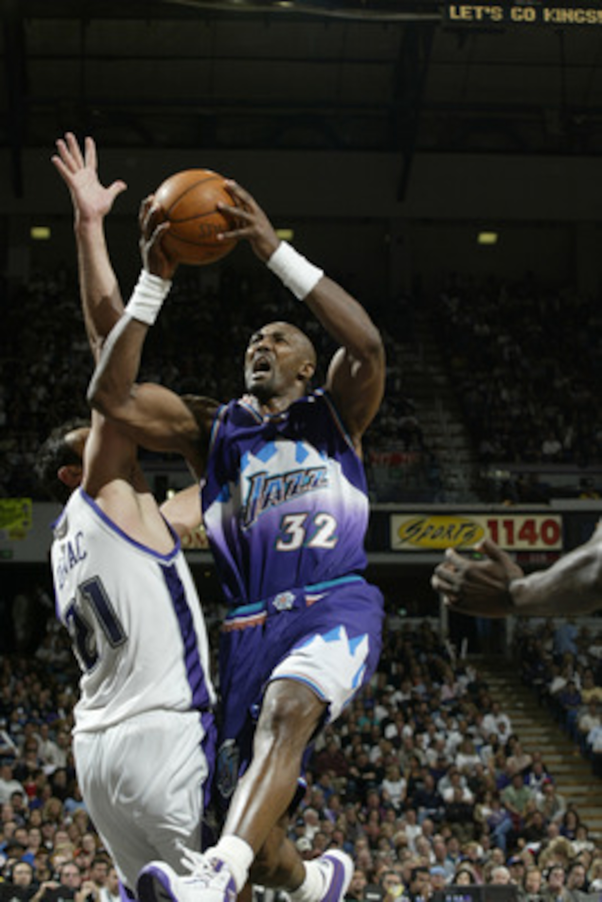 SACRAMENTO, CA - APRIL 30:  Karl Malone #32 of the Utah Jazz shoots past Vlade Divac #21 of the Sacramento Kings in Game five of the Western Conference Quarterfinals during the 2003 NBA Playoffs at Arco Arena on April 30, 2003 in Sacramento, California.  