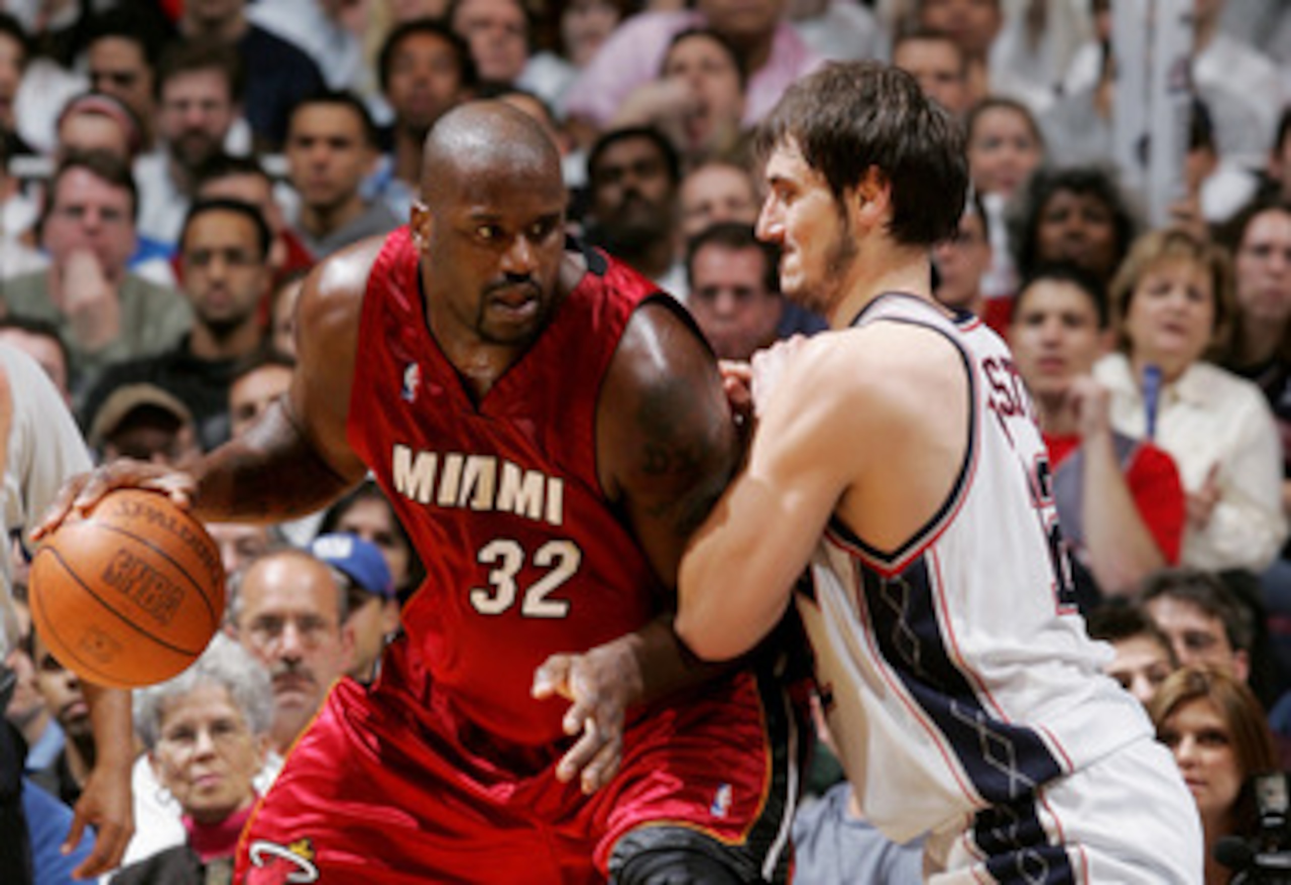 EAST RUTHERFORD - APRIL 28:  Shaquille O'Neal #32 of the Miami Heat moves the ball against Nenad Krstic #12 of the New Jersey Nets in Game three of the Eastern Conference Quarterfinals during the 2005 NBA Playoffs April 28, 2005 at Continental Airline Are