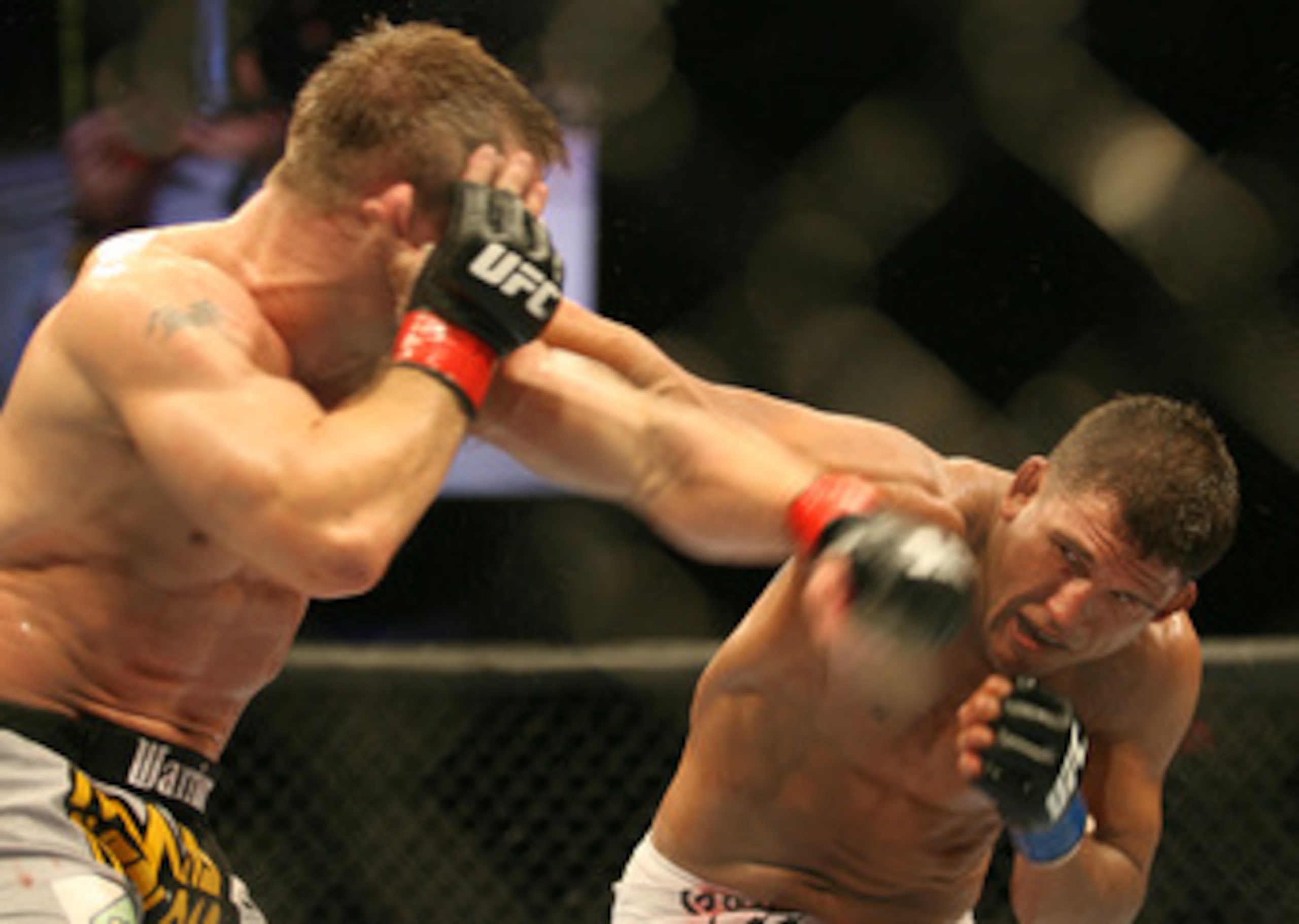 CHICAGO- OCTOBER 25: Sean Sherk (L) punches Tyson Griffin in a Lightweight bout at UFC's Ultimate Fight Night at Allstate Arena on October 25, 2008 in Chicago, Illinois. (Photo by Tasos Katopodis/Getty Images)