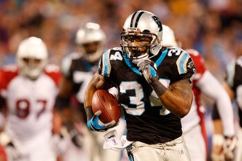 CHARLOTTE, NC - JANUARY 10:  Running back DeAngelo Williams #34 of the Carolina Panthers runs the ball against the Arizona Cardinals during the first quarter of the NFC Divisional Playoff Game on January 10, 2009 at Bank of America Stadium in Charlotte, N