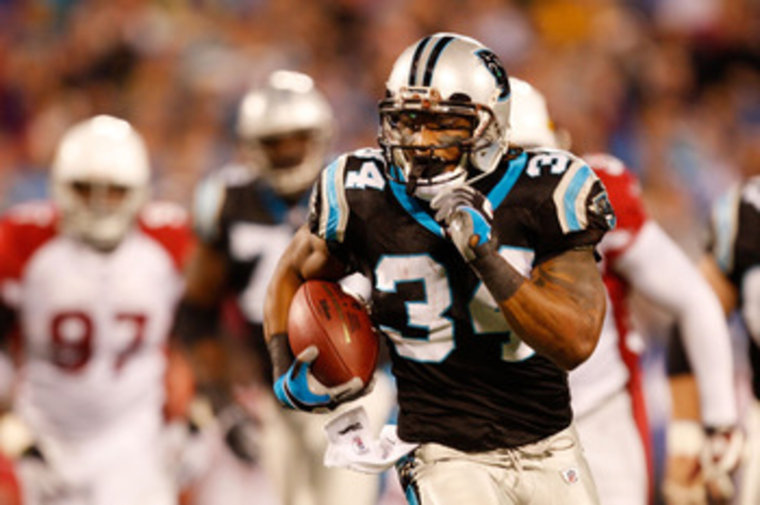 CHARLOTTE, NC - JANUARY 10:  Running back DeAngelo Williams #34 of the Carolina Panthers runs the ball against the Arizona Cardinals during the first quarter of the NFC Divisional Playoff Game on January 10, 2009 at Bank of America Stadium in Charlotte, N