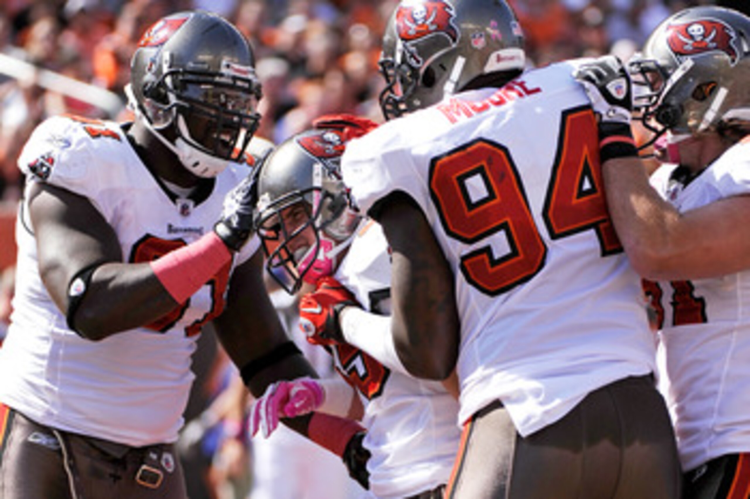 CINCINNATI, OH - OCTOBER 10:  Stylez G. White #91 and Kyle Moore #94 of the Tampa Bay Buccaneers celebrate with teammate Cody Grimm #35 of the Buccaneers after Grimm's 11-yard interception return for a touchdown in the first half against the Cincinnati Be