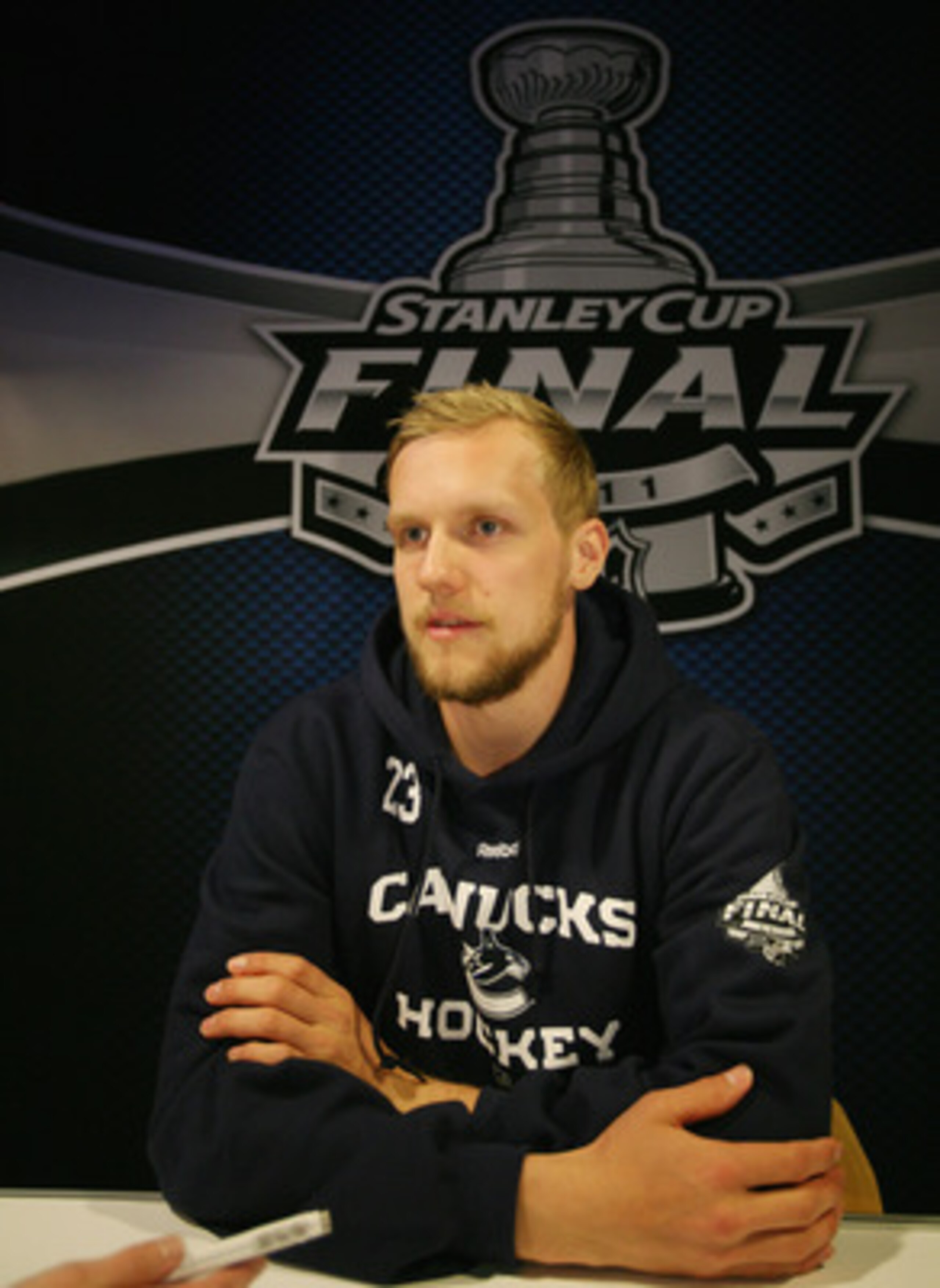 VANCOUVER, BC - MAY 31: Christian Ehrhoff #5 of the Vancouver Canucks meets with the media following a practice session the day before the opening game of the 2011 NHL Stanley Cup Finals at the Rogers Arena on May 31, 2011 in Vancouver, Canada.  (Photo by