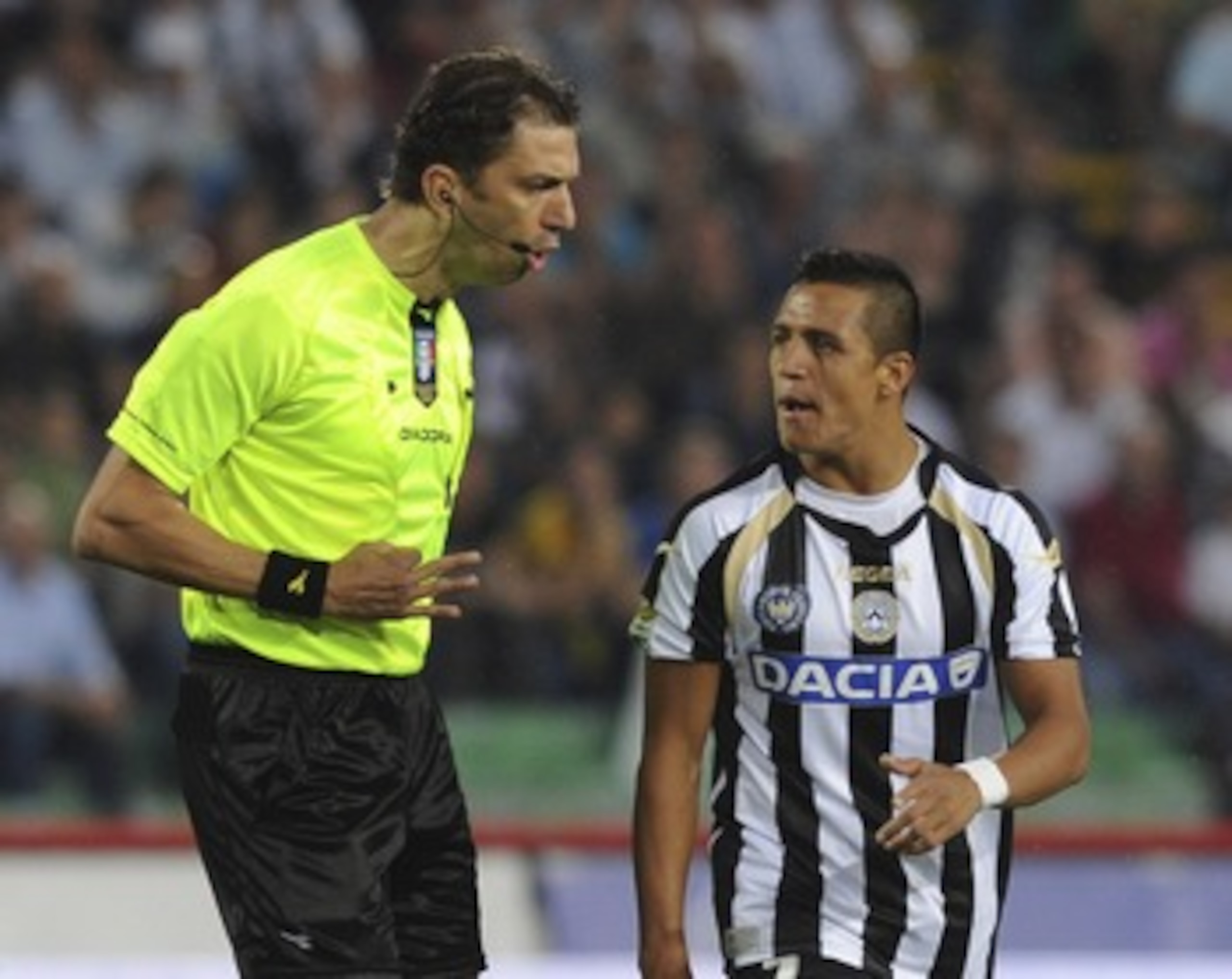 UDINE, ITALY - MAY 22:   Referee Paolo Tagliavento (L) talks with Alexis Samnchez of Udinese during the Serie A match between Udinese Calcio and AC Milan  at Stadio Friuli on May 22, 2011 in Udine, Italy.  (Photo by Dino Panato/Getty Images)