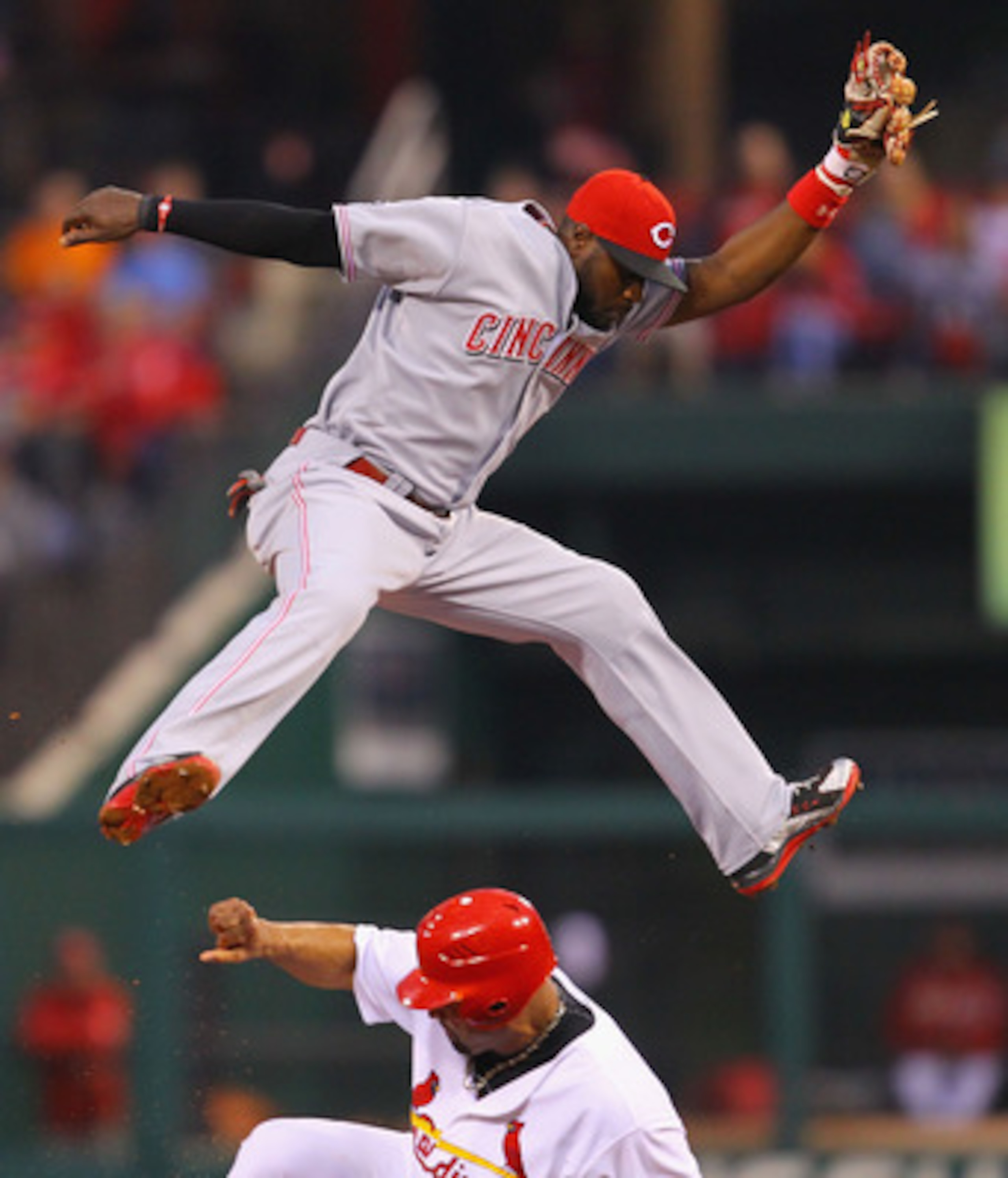 ST. LOUIS, MO - APRIL 24: Albert Pujols #5 of the St. Louis Cardinals steals second base against Brandon Phillips #4 of the Cincinnati Reds at Busch Stadium on April 24, 2011 in St. Louis, Missouri.  (Photo by Dilip Vishwanat/Getty Images)